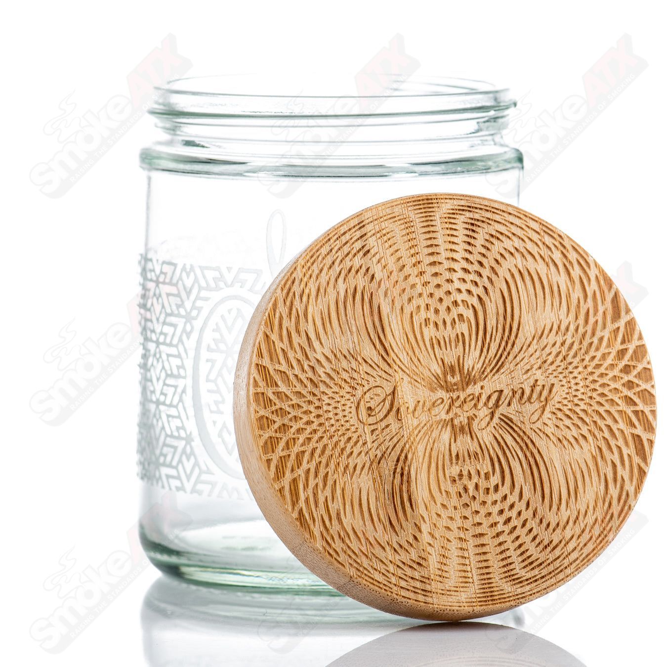 Sovereignty Glass Tri Star Pattern Nug Jar with bamboo lid, clear glass container for storage and organization.