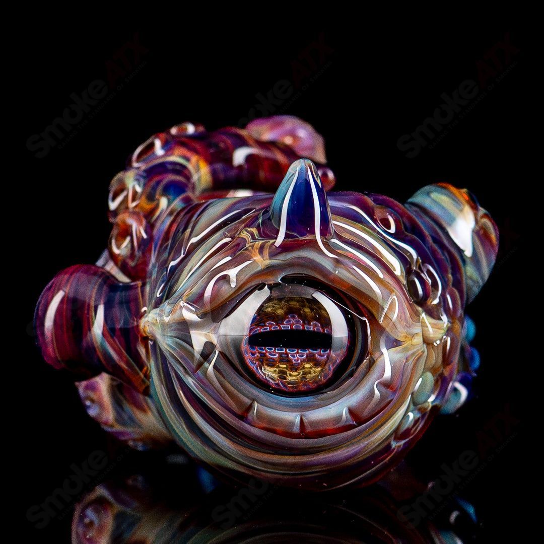 Hand pipe from Mako Glass Seamonster Spoon series, clear heady glass with colorful sea creature design and intricate details.