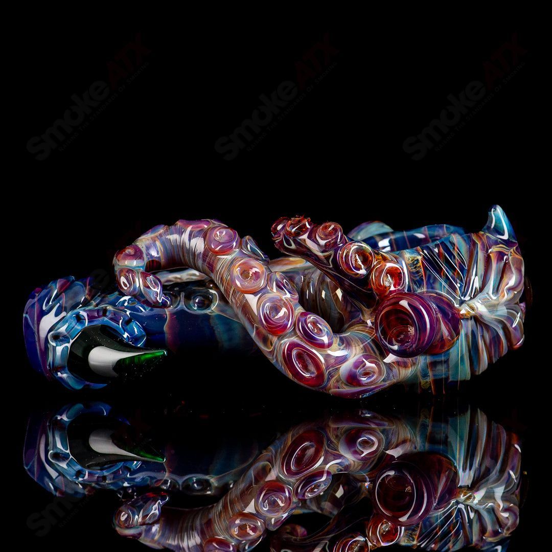 Colorful Mako Glass Seamonster Spoon hand pipe with intricate glass design and detailed sea monster motif.