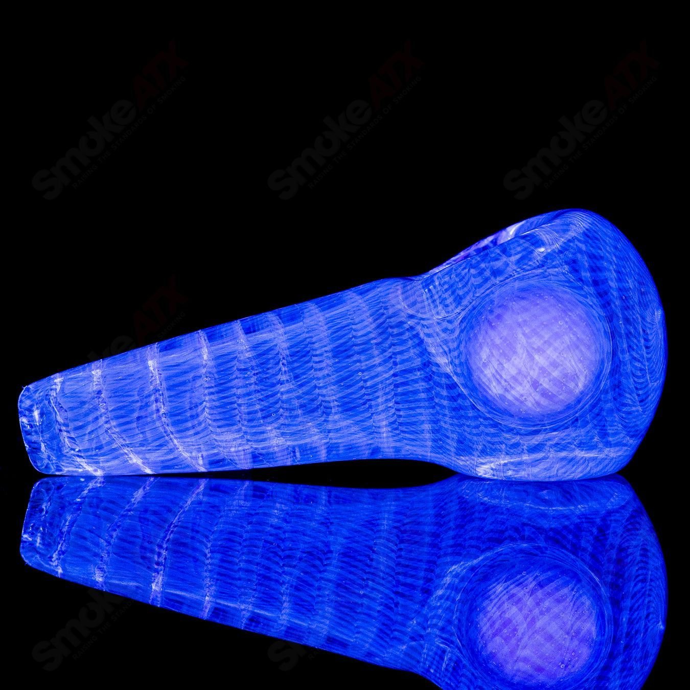 UV Fume Spoon by JMK Glass, hand pipe with vibrant UV-reactive fume design and clear glass craftsmanship.