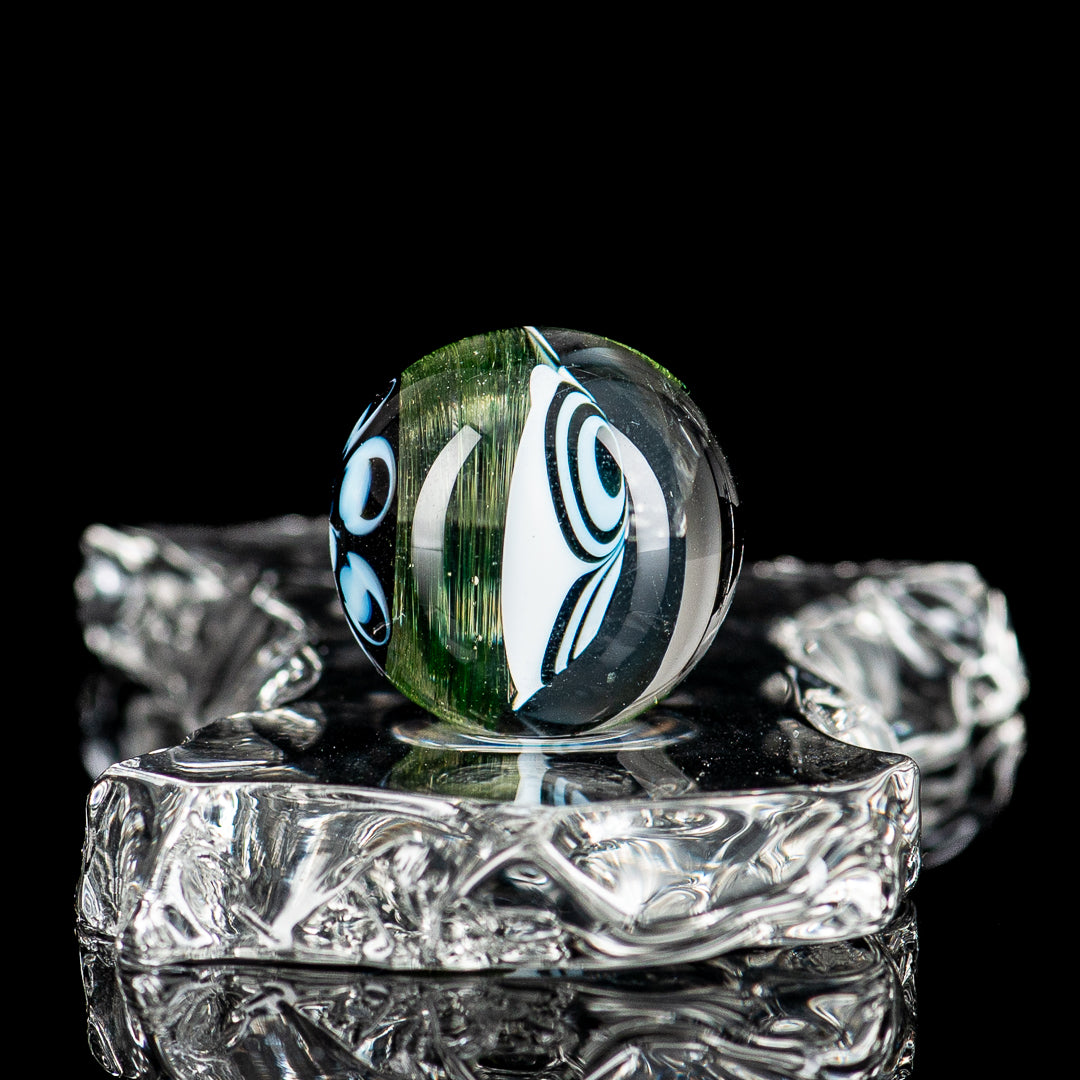 Indo Glass UV Dotstack Skull Marble made of glass with colorful dot and skull design, showcasing intricate patterns and vibrant colors.