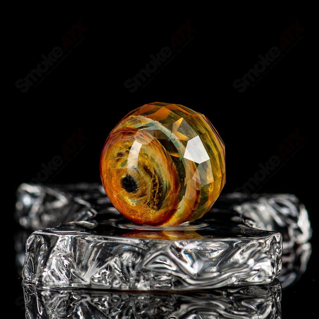 Colorful Fatal Facets glass marbles featuring intricate patterns and smooth, rounded surfaces from Fatal Facets.