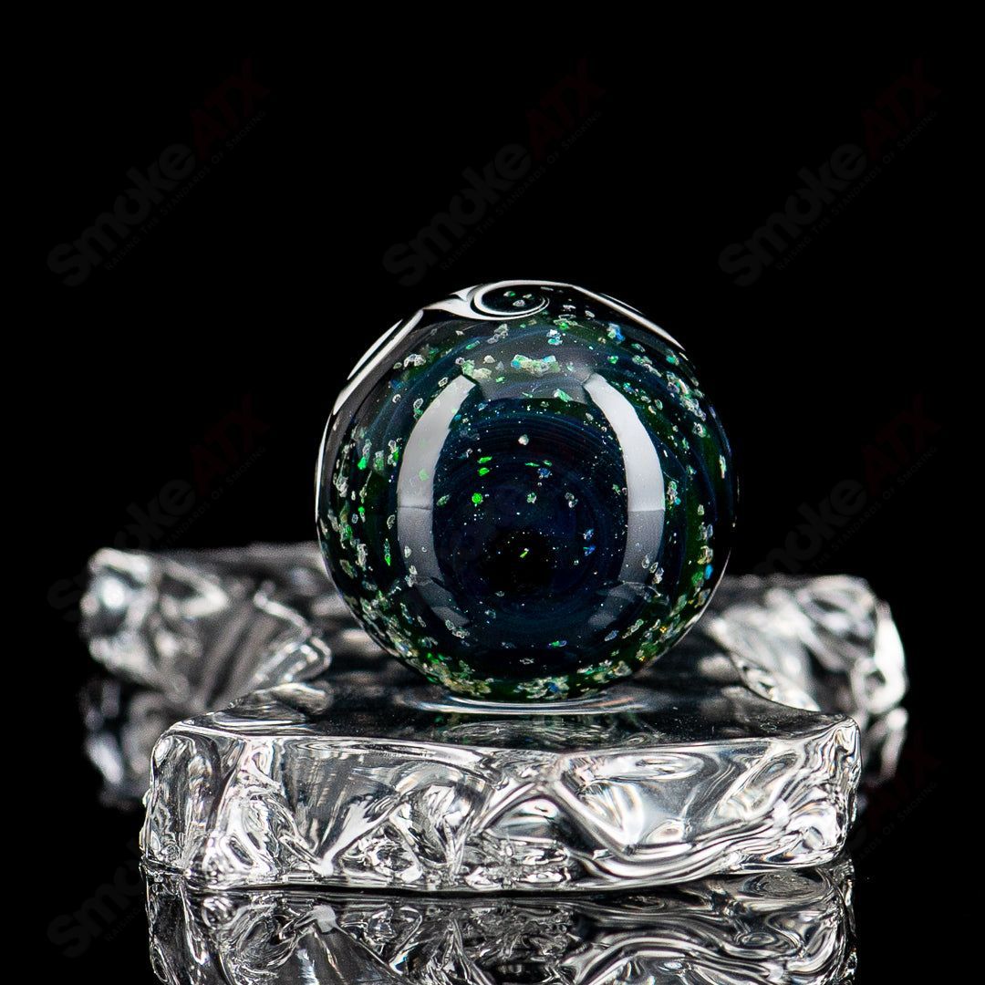 Black Magic UV Pinwheel Top glass marble by Indo Glass, featuring vibrant colors and intricate pinwheel design.