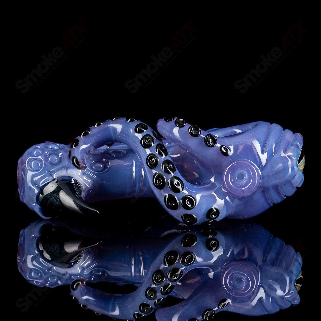 Colorful Mako Glass Seamonster Spoon hand pipe with detailed sea creature design, made from vibrant heady glass.