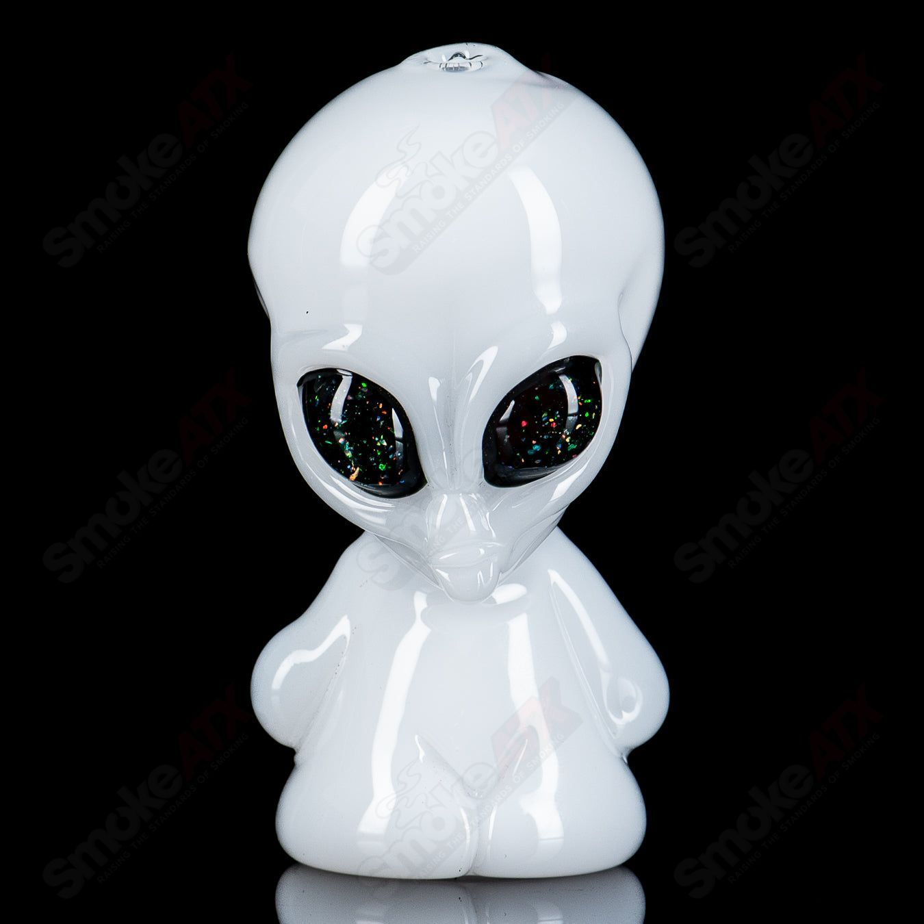 White alien hand pipe with UV crushed opal eyes, made by Ghost Glass, featuring a heady glass design for smoking.