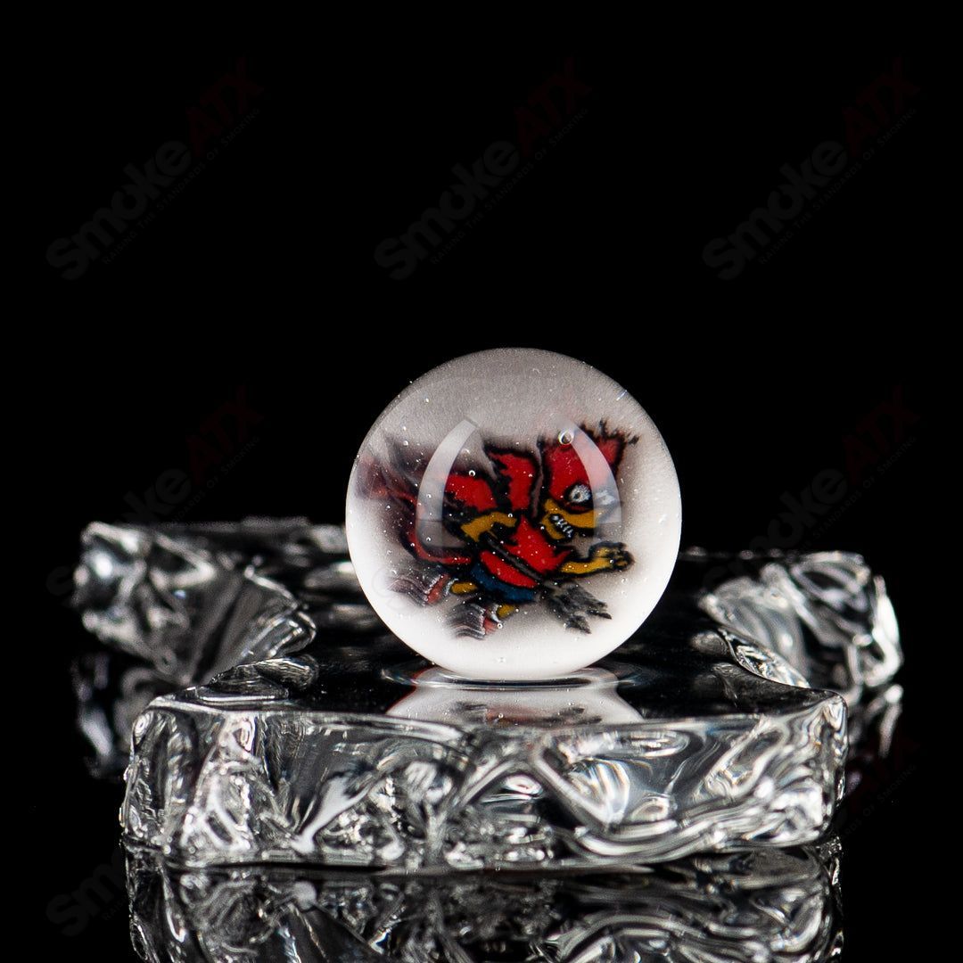 Colorful Devil Bart Mib Indo Glass marble with intricate patterns, showcasing vibrant design on a smooth glass surface.