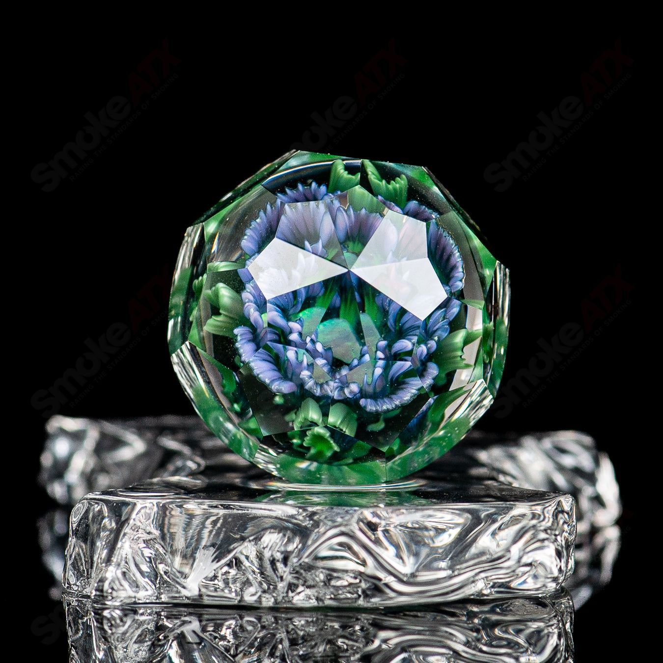 Close-up of Flower Marble #2 by Fatal Facets, a glass impact marble featuring colorful floral and marble patterns.