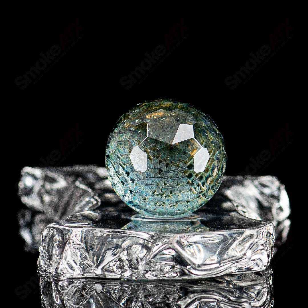 Faceted UV composite marble Indo Glass glass with intricate facets, showcasing a modern, decorative glass piece with a textured surface.