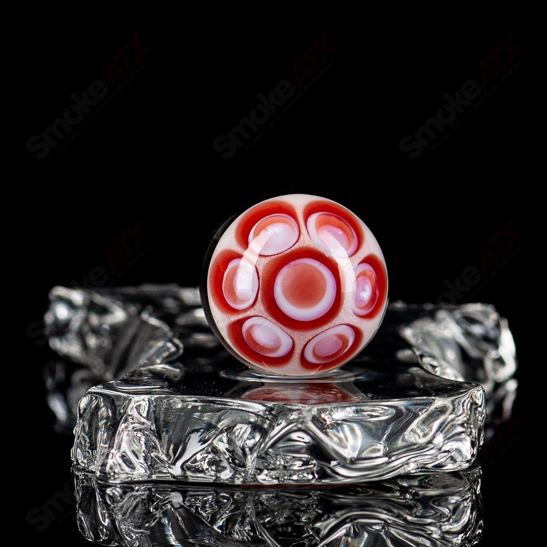 Colorful Devil Bart Mib Indo Glass marble with intricate swirl patterns, crafted by Indo Glass, featuring vibrant red and black hues.
