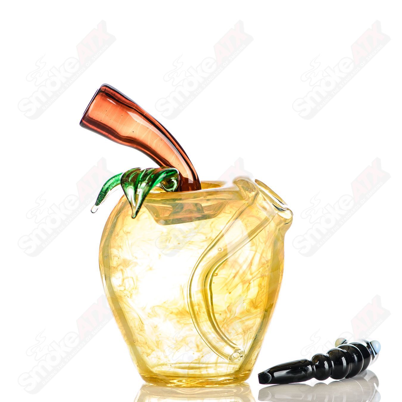 Yellow apple-shaped rig with a worm dabber and pouch, made by Pouch Glass, designed for concentrate use in heady glass style.