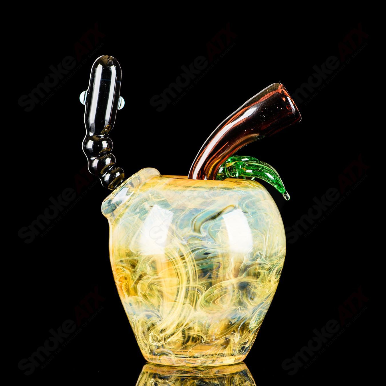 Yellow apple-shaped rig with worm dabber and pouch, made by Pouch Glass, designed for concentrate dabbing in heady glass style.