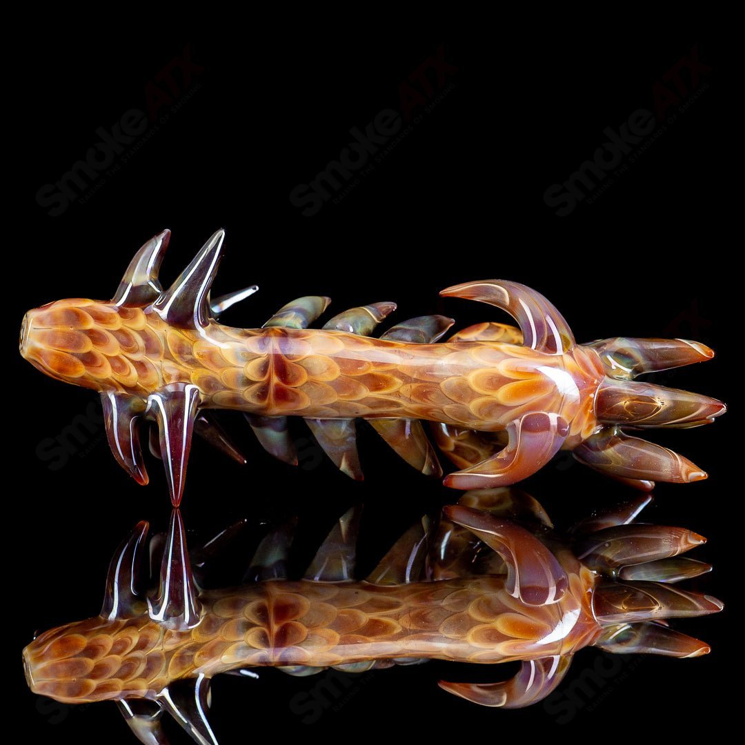 Focused Fire Heady Glass Sherlock pipe featuring a dragon design, with intricate details and vibrant colors.