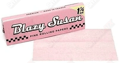 Pink Blazy Susan 1 1/4 rolling papers for rolling cigarettes or joints, featuring vibrant pink design and smooth paper texture.