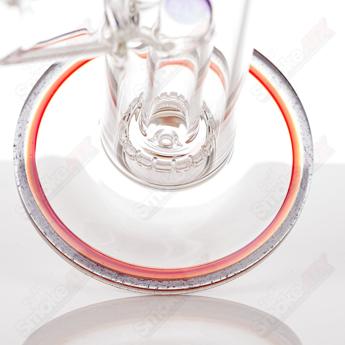 Toro 18mm circular to 13-arm perc glass straight tube with colorful foot and mouthpiece accents, designed for smooth smoking.