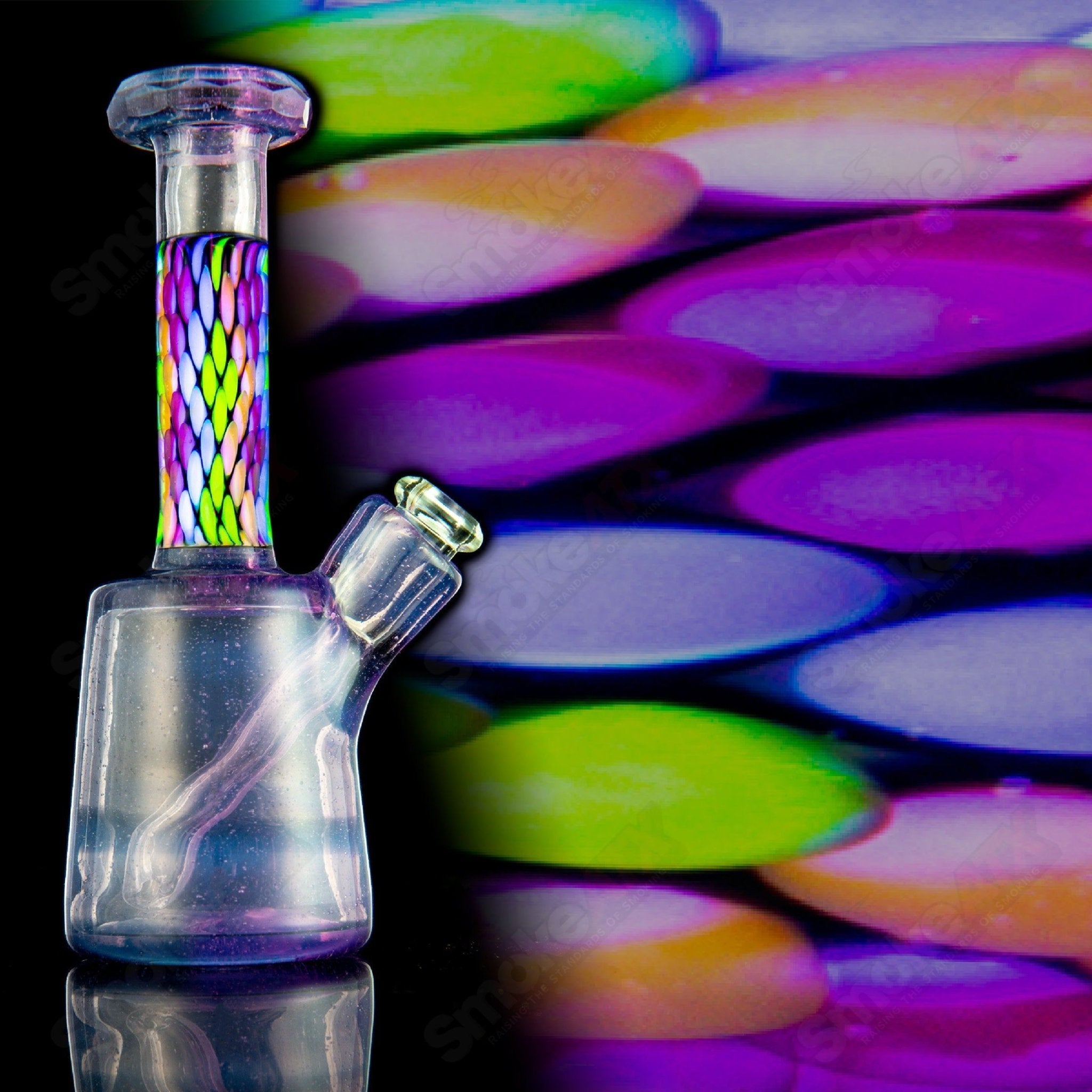 Faceted UV mini concentrate rig by BCM Glass, made of heady glass with colorful UV-reactive features and a compact design.