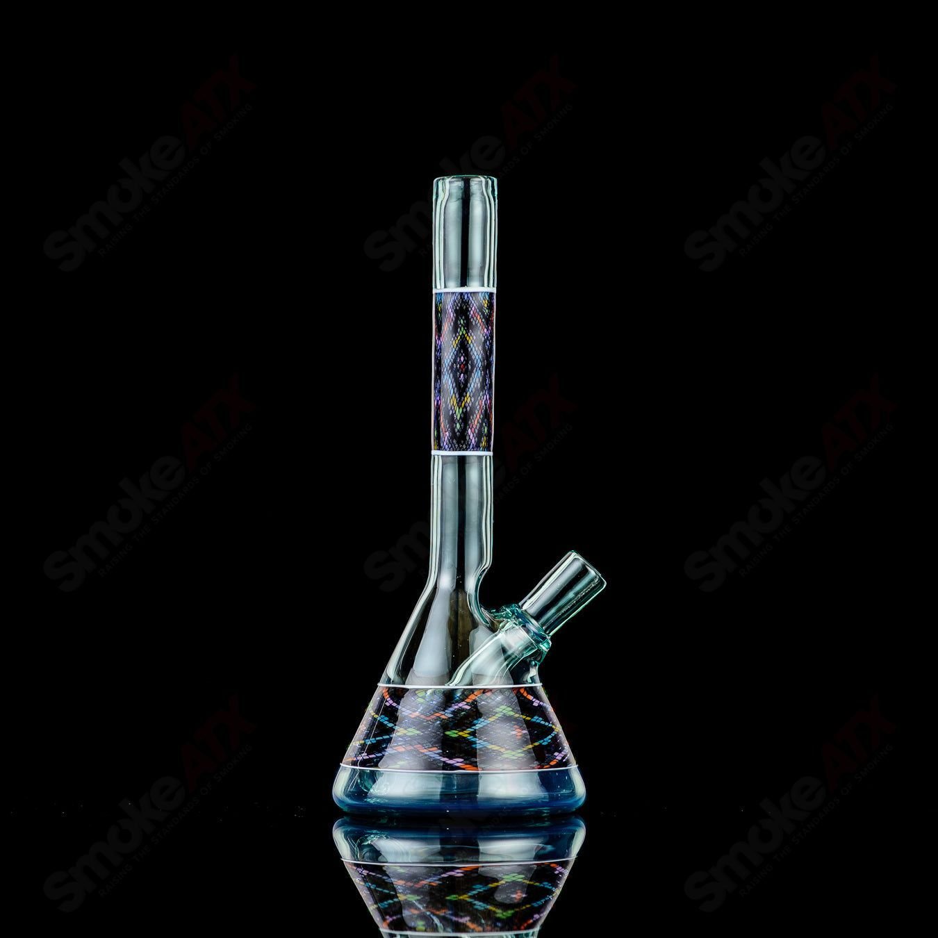 John W Glass Filla Tube, a colorful heady glass concentrate rig with intricate designs and a clear glass body.