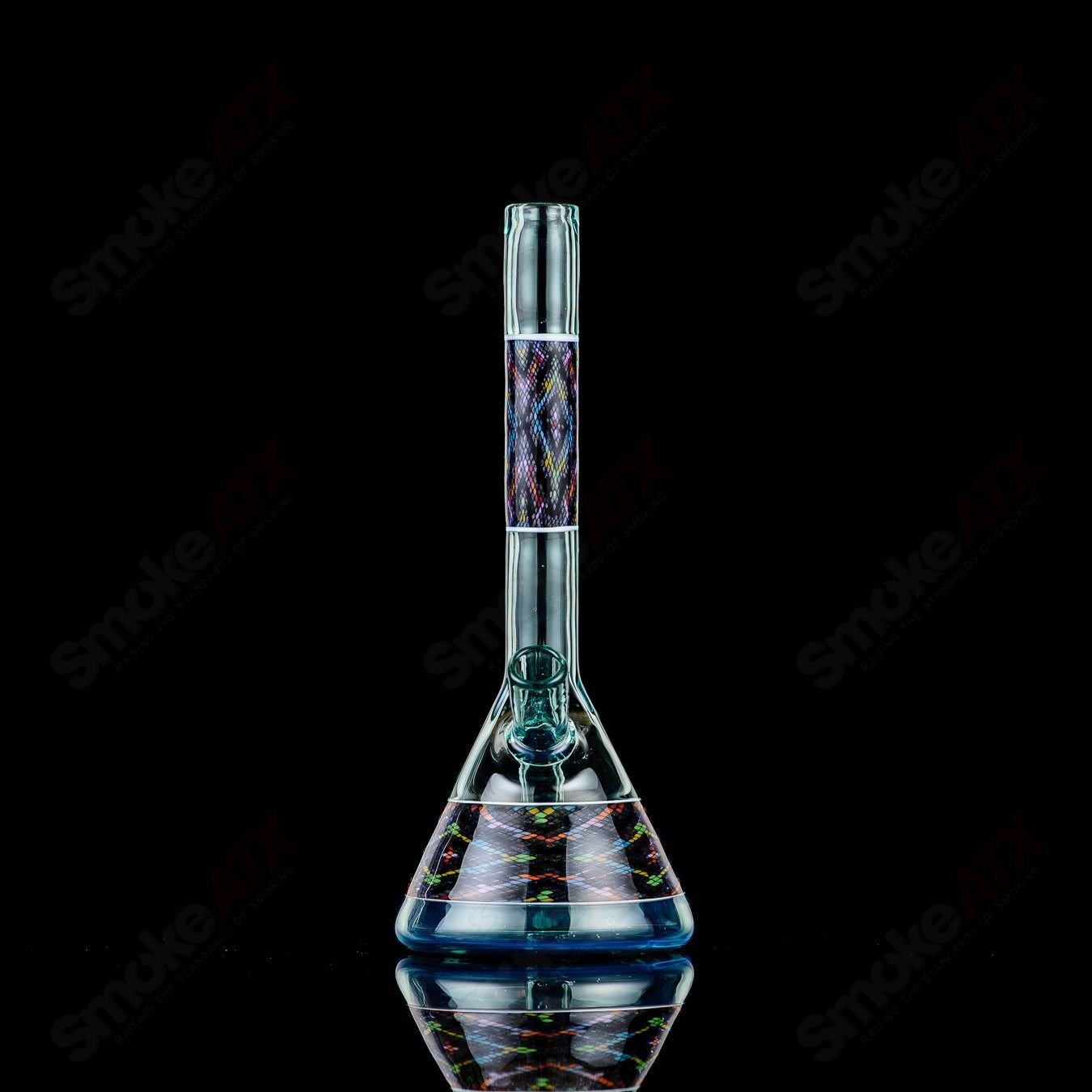 John W Glass Filla Tube, a clear heady glass concentrate rig with intricate designs and a sturdy base for dabbing.