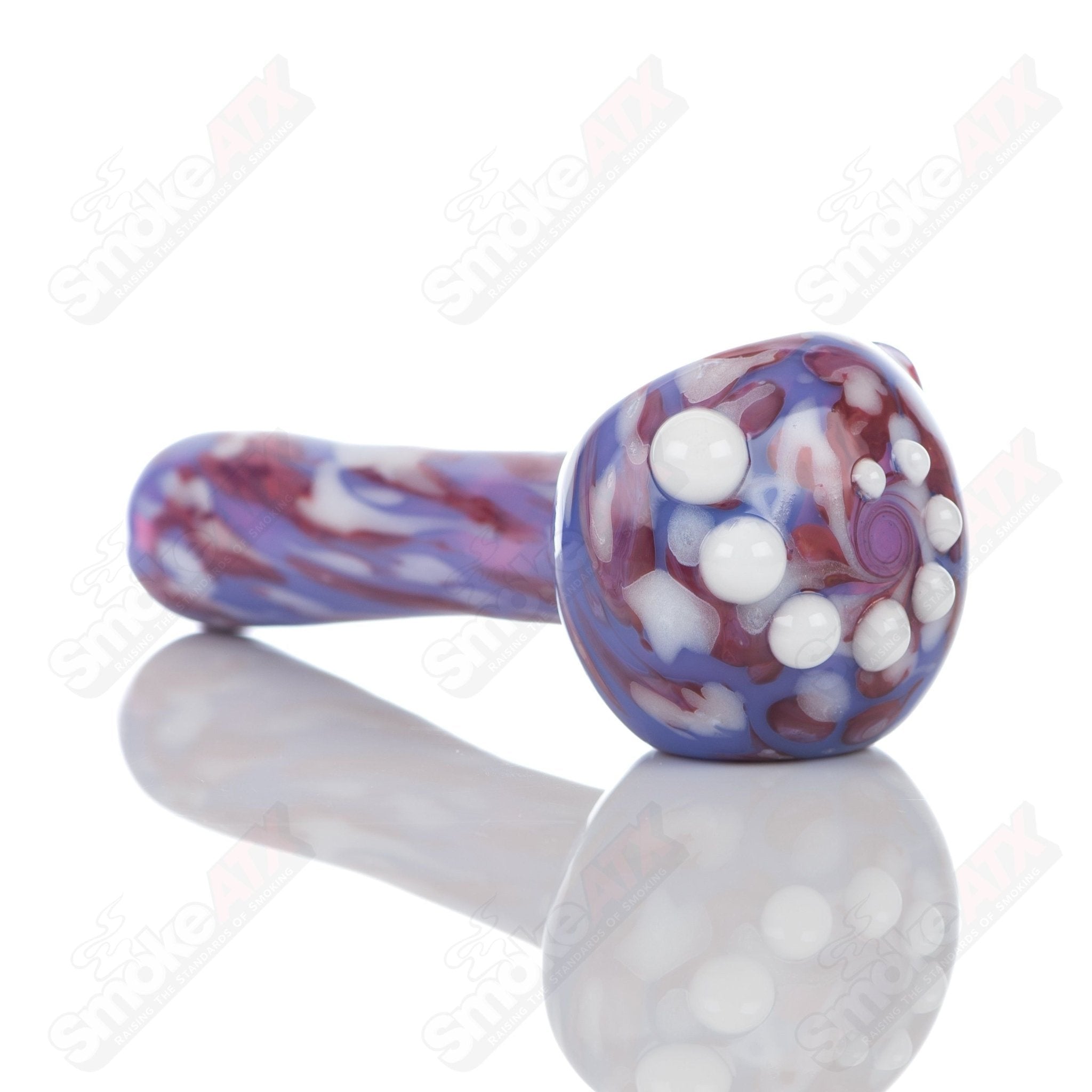 Purple splatter glass spoon pipe by Adventures In Glass Blowing, showcasing a colorful, artistic hand pipe design.