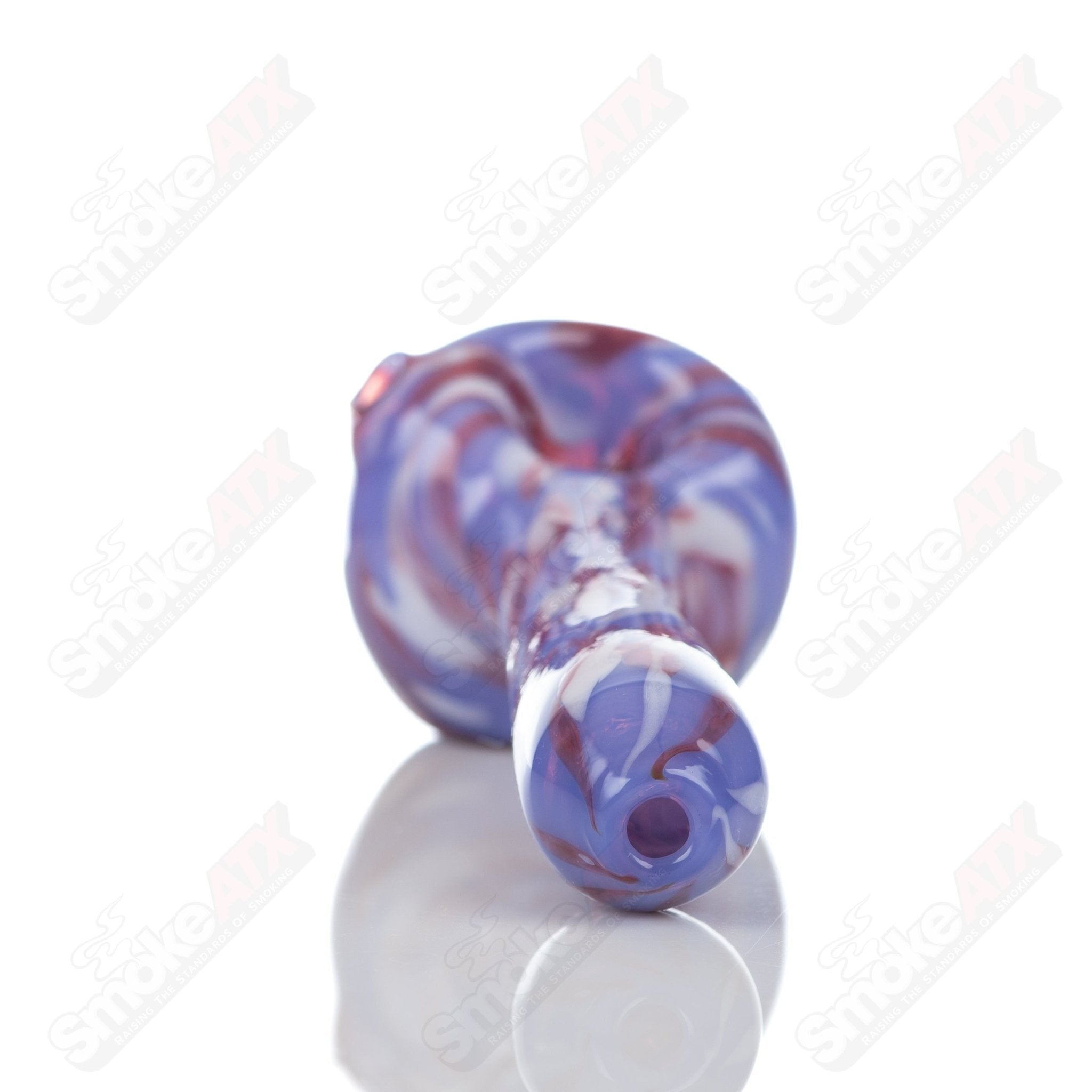 Purple splatter glass spoon pipe from Adventures In Glass Blowing, featuring a detailed design and smooth glass finish.
