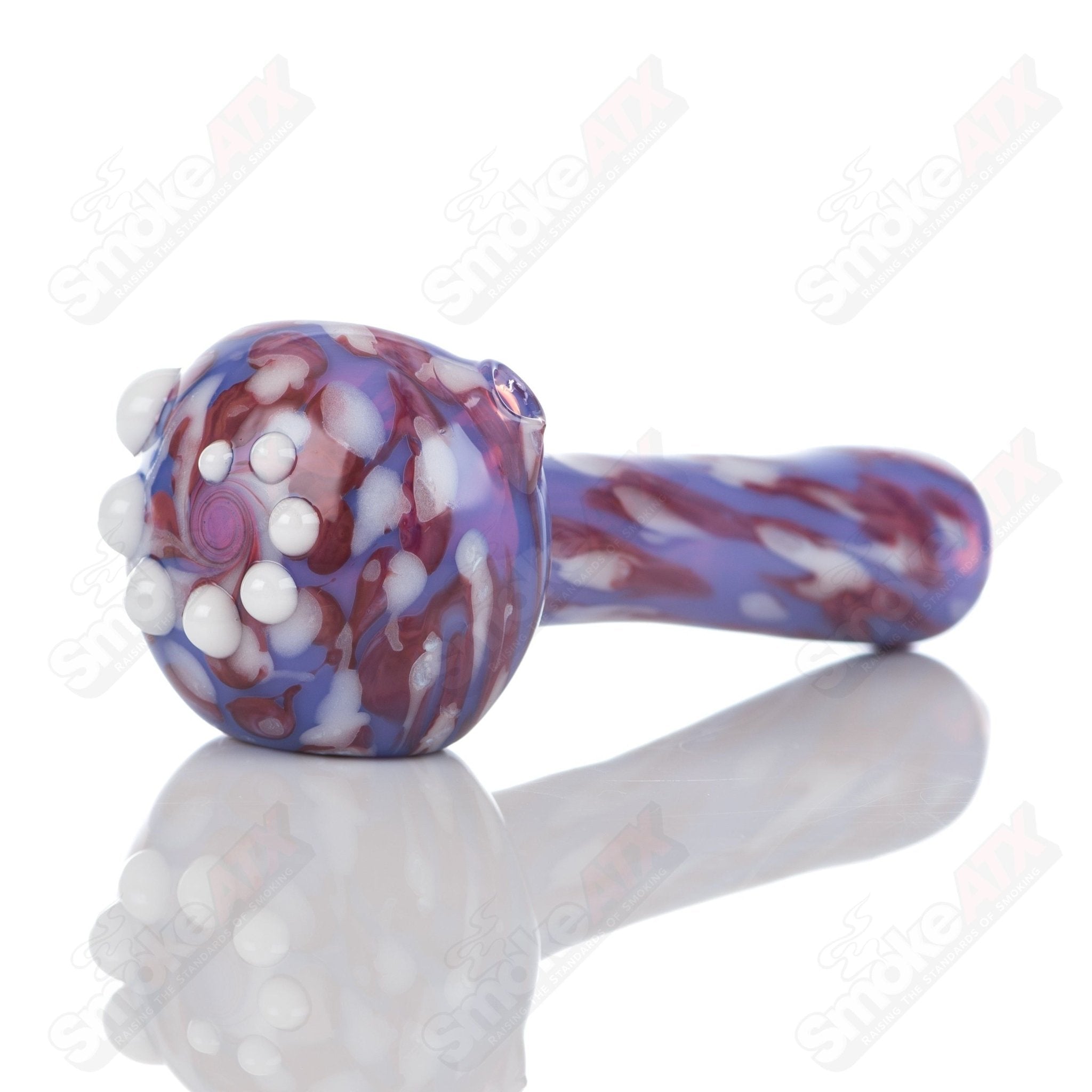 Purple splatter glass spoon pipe by Adventures In Glass Blowing, featuring a colorful, handcrafted design for smoking.