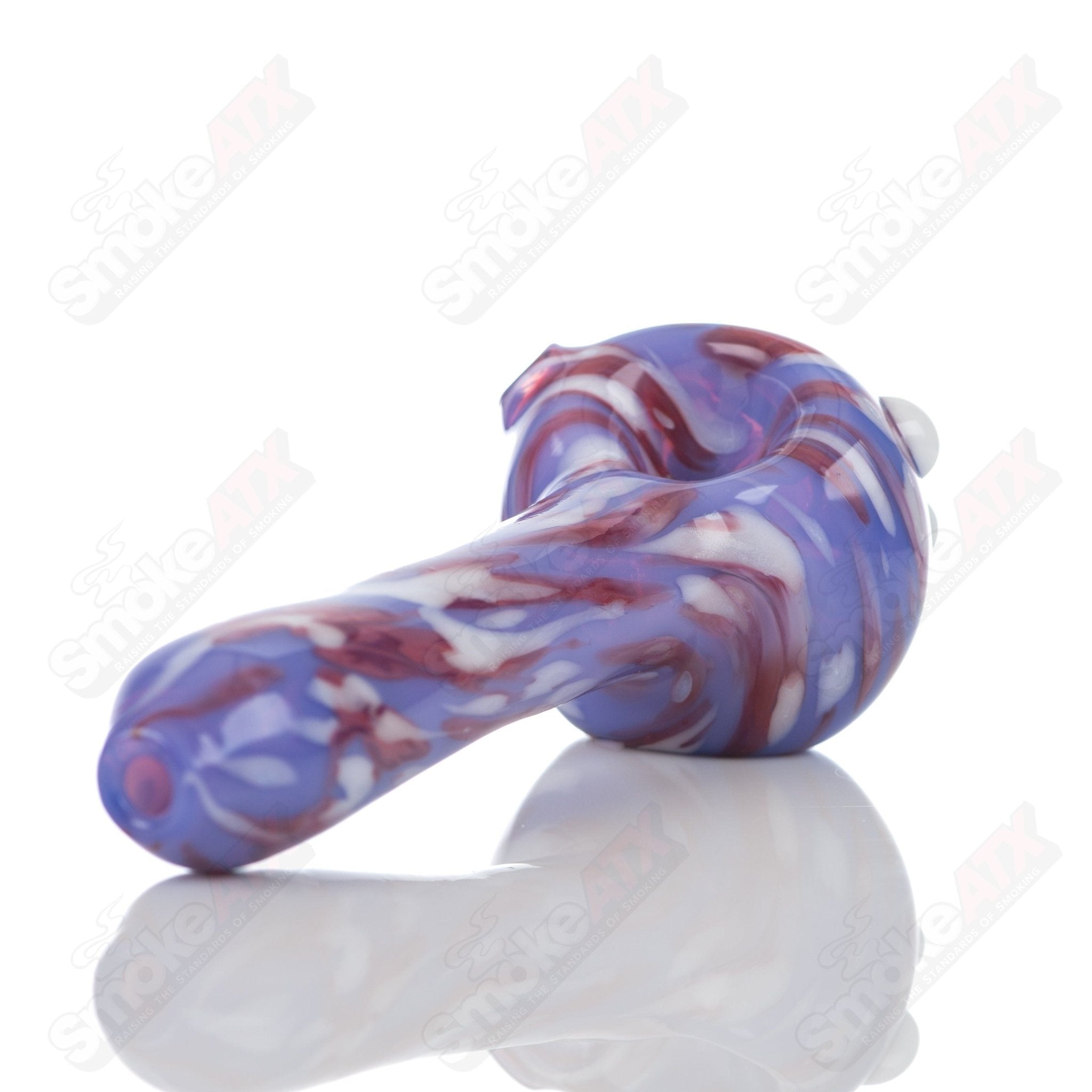 Purple splatter glass spoon pipe from Adventures In Glass Blowing, featuring a colorful, artistic design and smooth glass finish.
