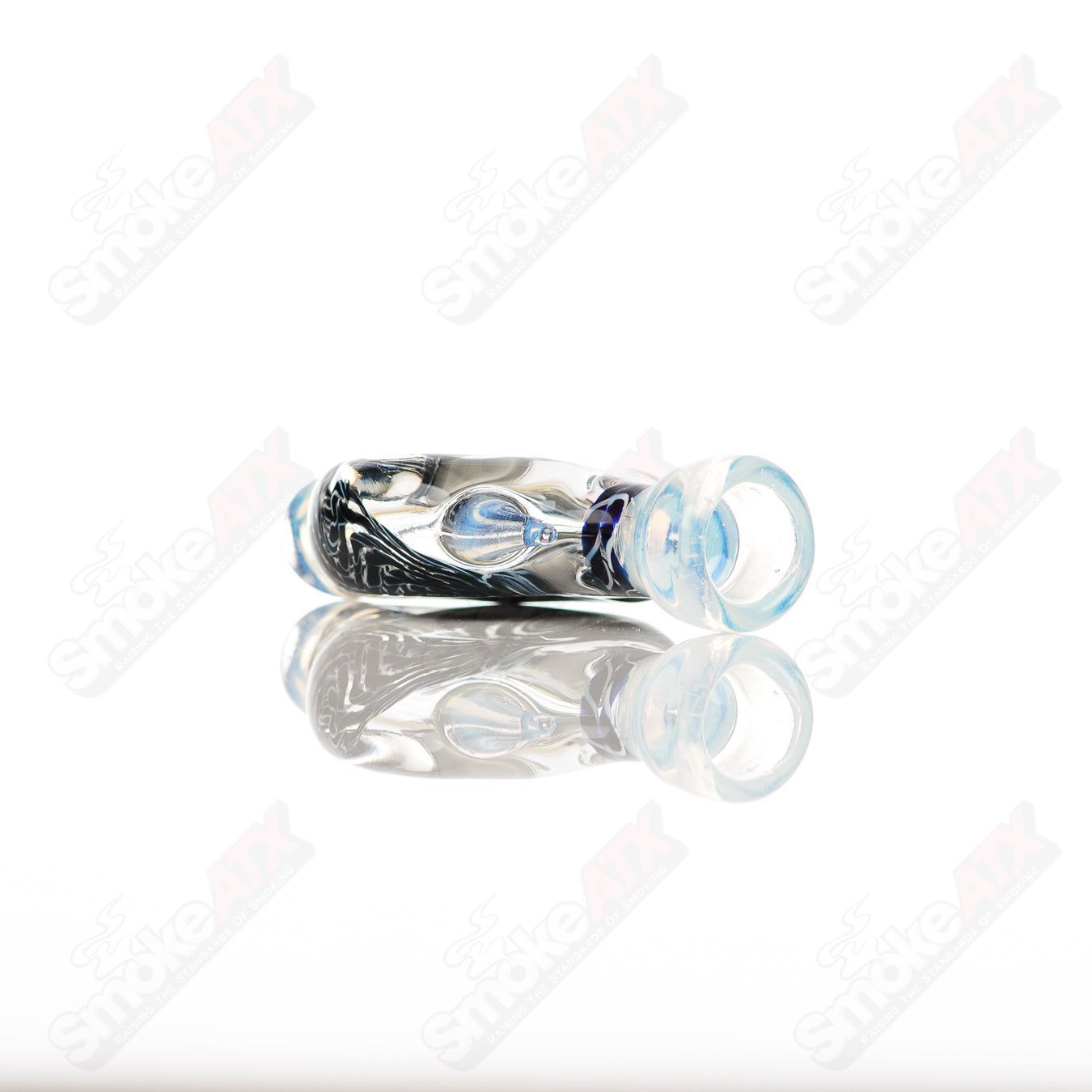 Small glass Chillum by Baby Dabs, designed for dab consumption, showcasing a compact, clear glass pipe with intricate details.