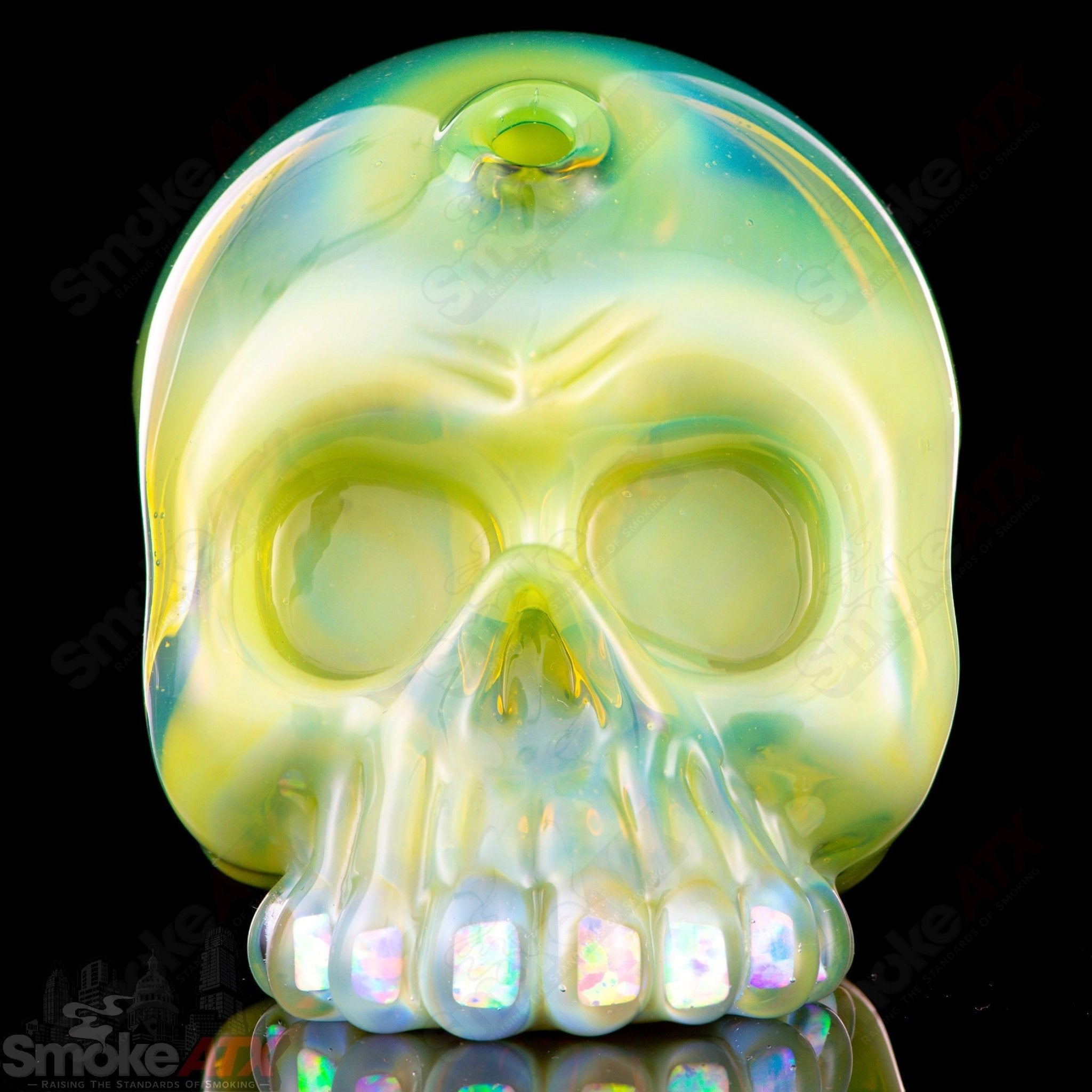 Carsten Carlile 10mm Guava Roots Skull Shredder heady glass concentrate rig with intricate skull design and vibrant colors.