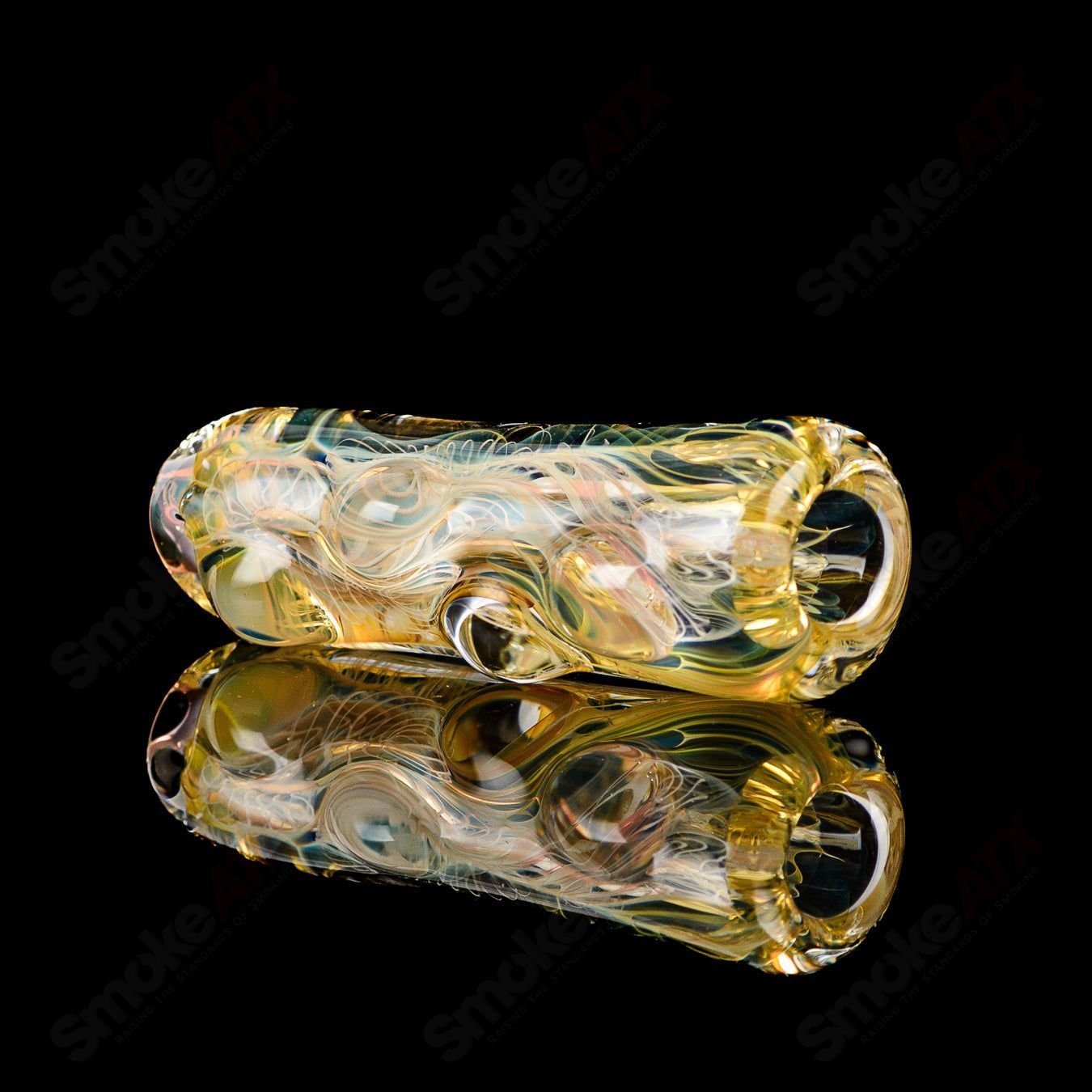 Clear Texas Hot Glass Taster Chillum with a simple design, showcasing a smooth, rounded glass smoking accessory.