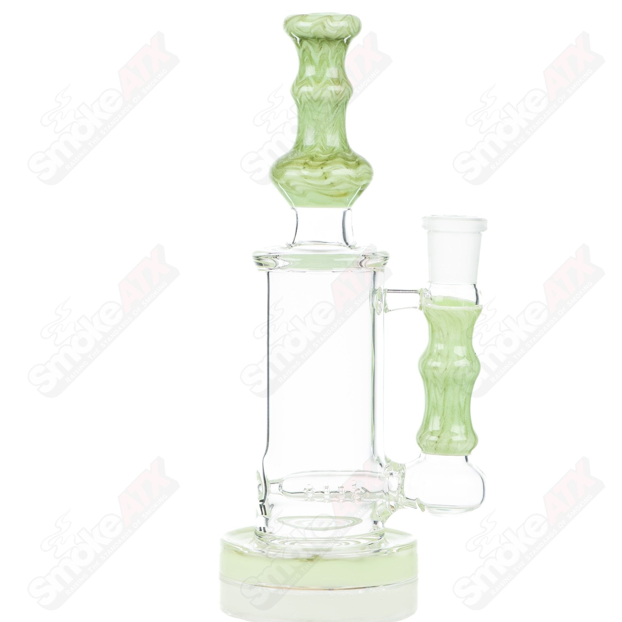 Tagle Glass 18mm 50mm wrap and rake inline tube bubbler made of clear glass with detailed design.