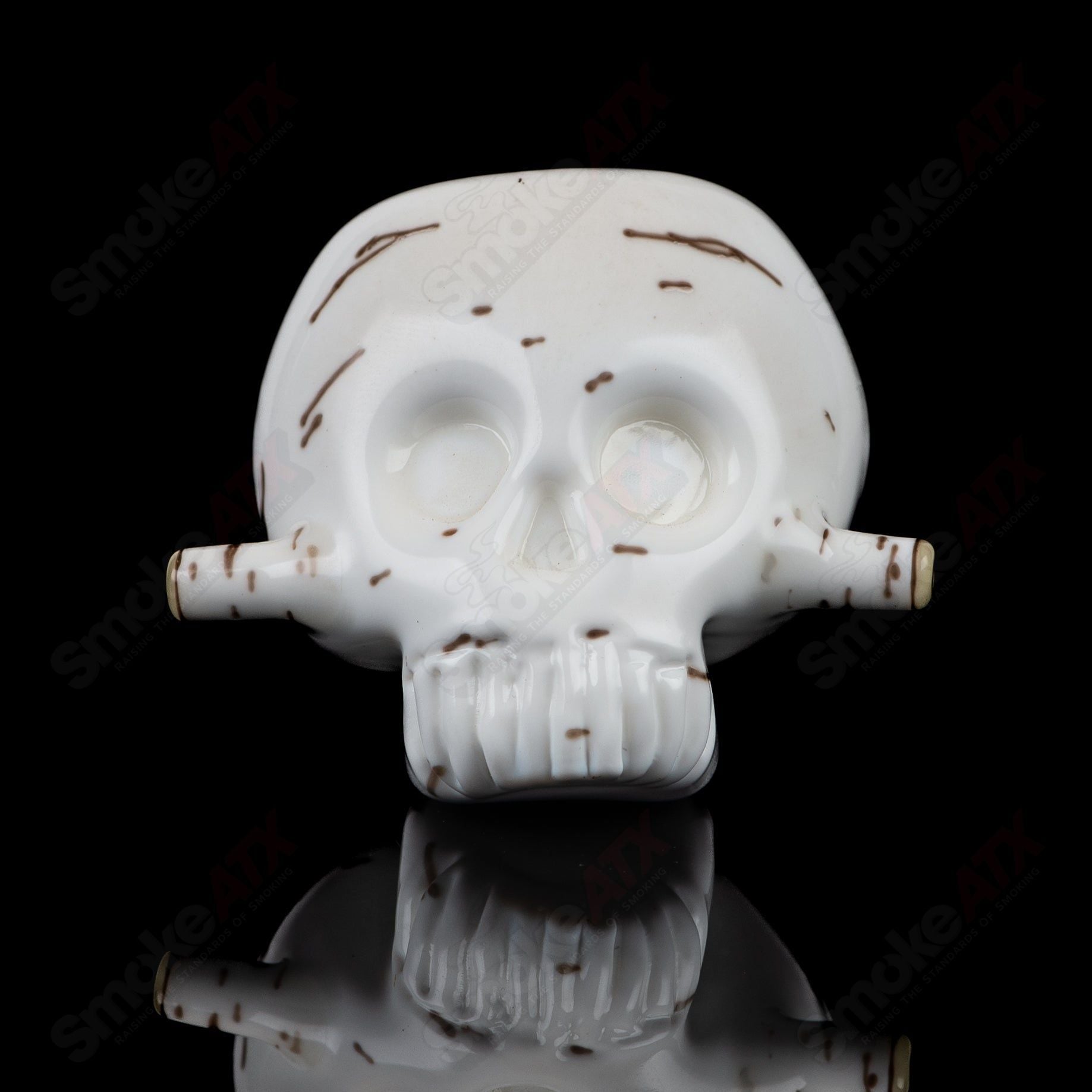 Foster Glass Heady Glass skull-shaped spoon pipe featuring a birch wood design and intricate glass craftsmanship.