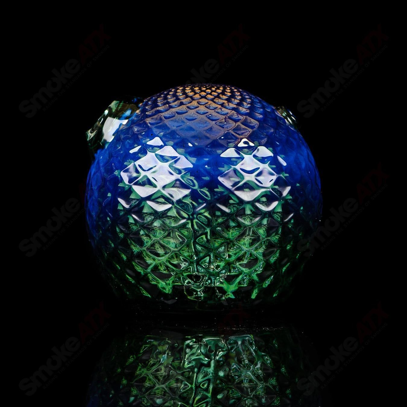 Fumed color sphere rig for concentrates by James Lang, featuring a sleek glass design with vibrant, swirling hues.