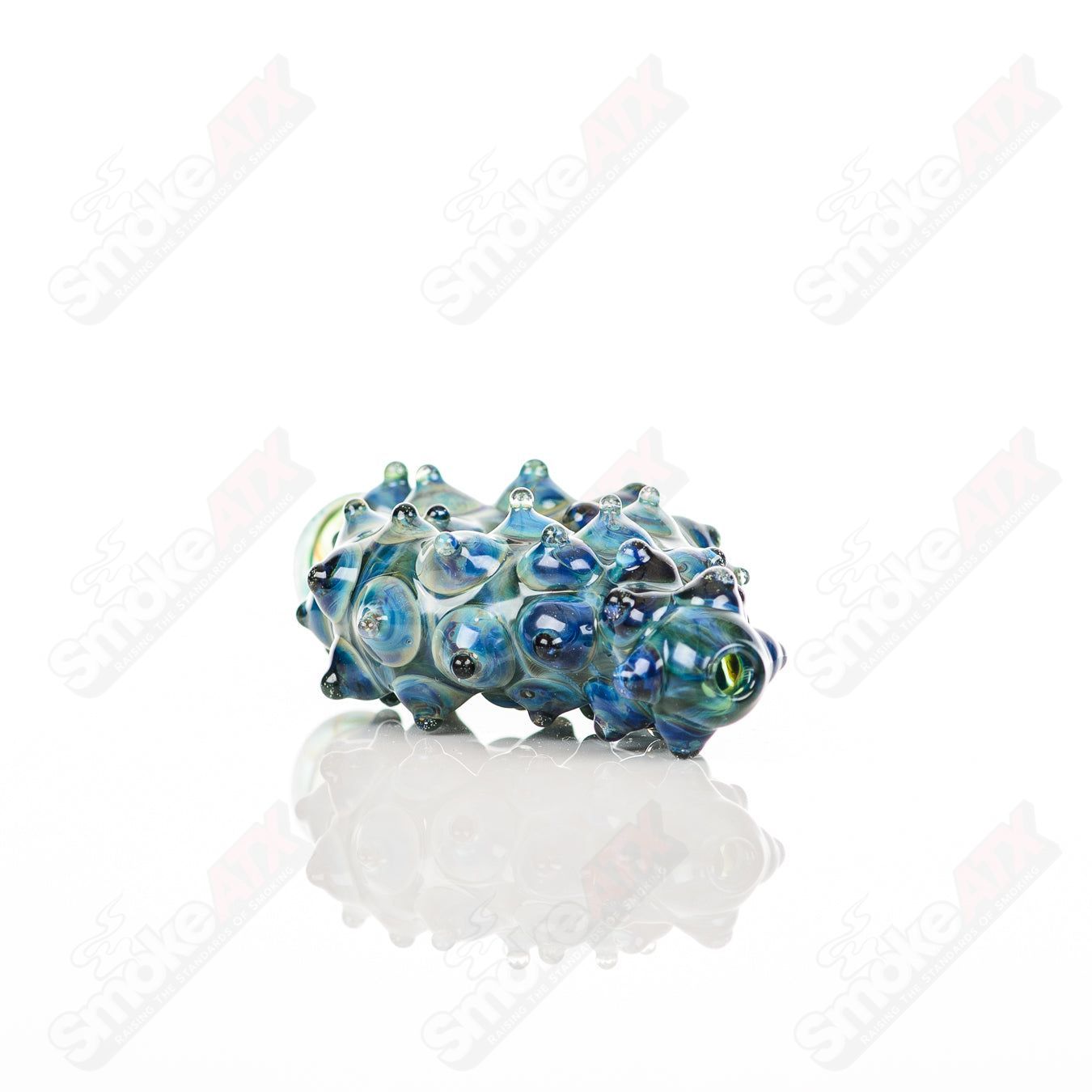 Large donut-shaped glass chillum by Baby Dabs, designed for baby dabs, featuring a colorful and textured glass construction.
