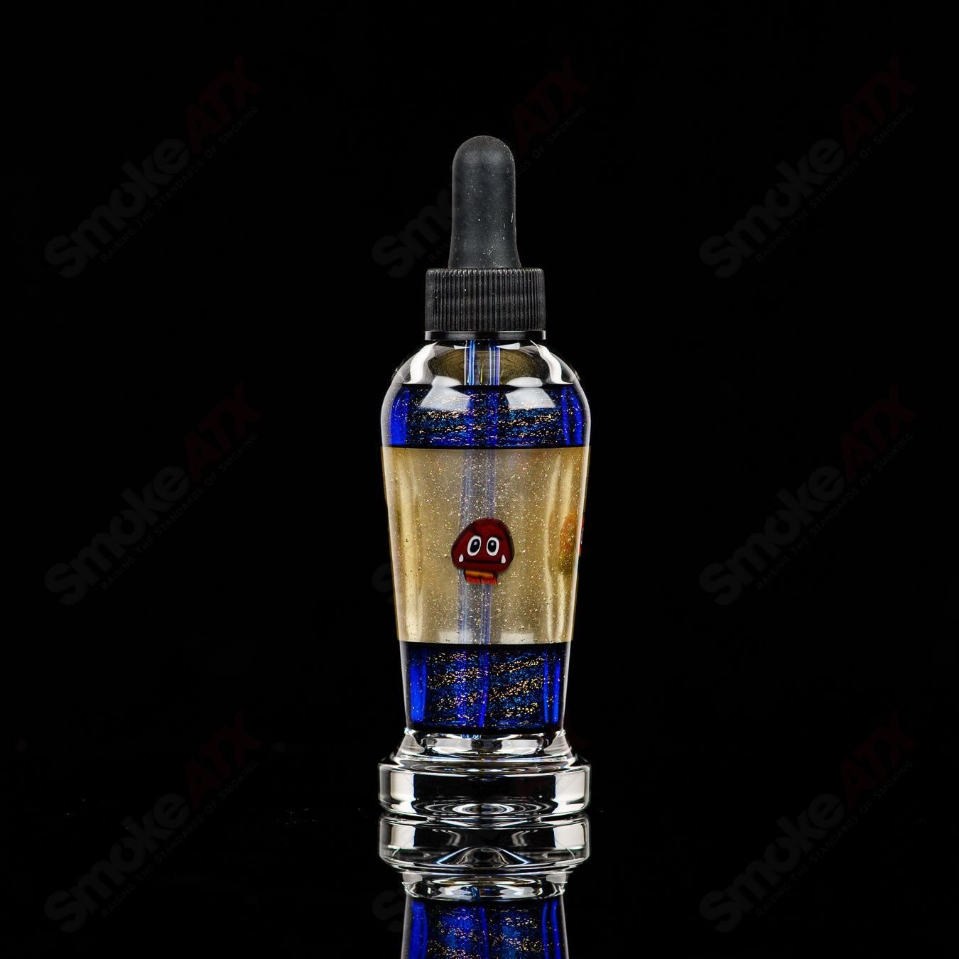 Micro Glass heady spray bottle with two spray nozzles, featuring a clear glass body and compact design for easy use.