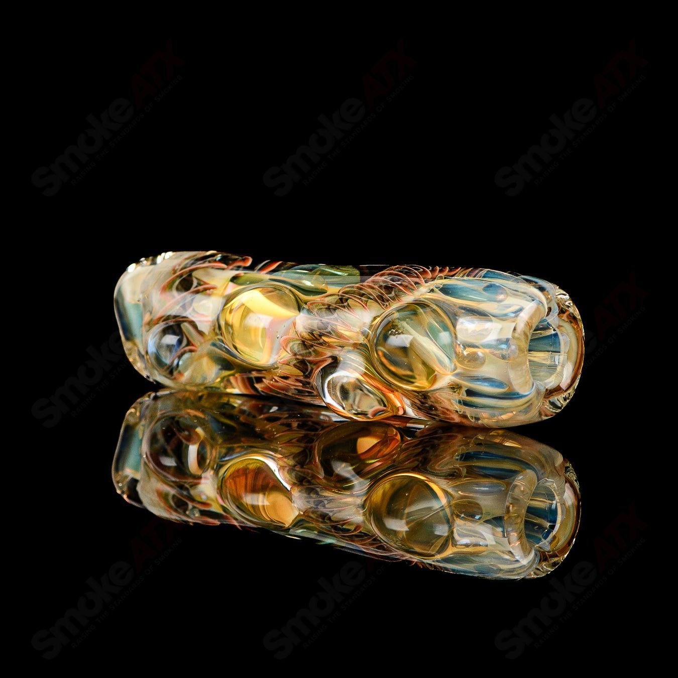 Texas Hot Glass Taster #23 Chillum glass pipe, clear and compact with a smooth mouthpiece and artistic design details.