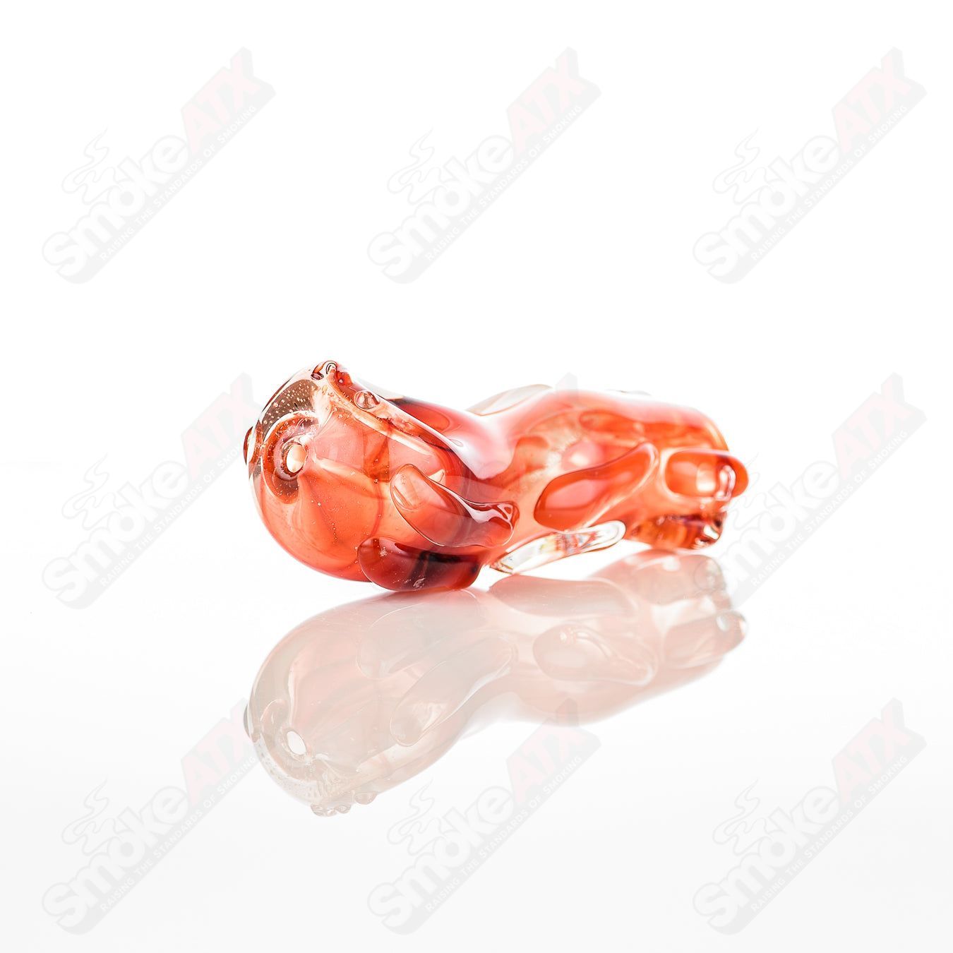 Glass pipe in the shape of a spoon, made by Nobody, featuring clear glass with smooth curves and a bowl for smoking.