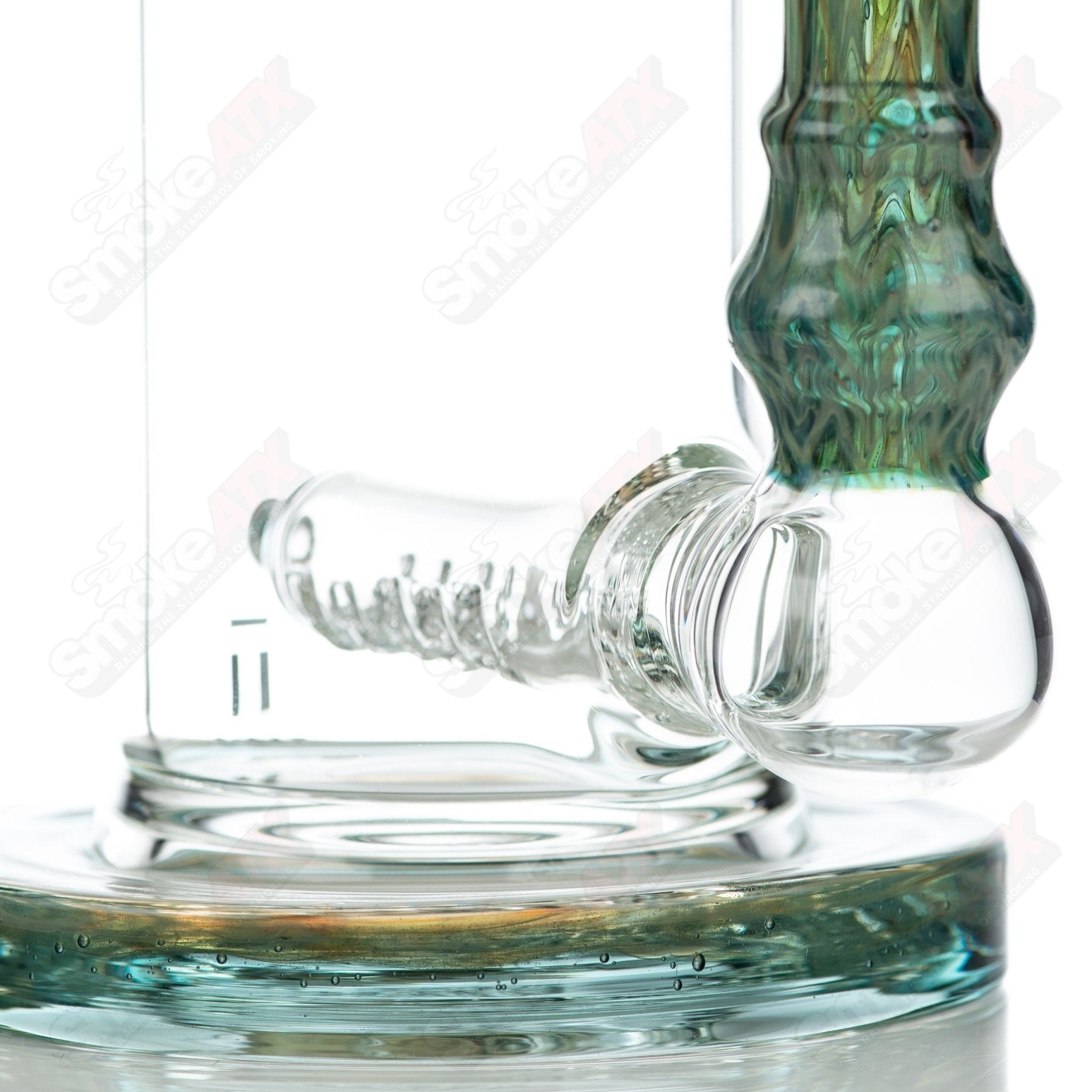 Tagle Glass 14mm 60mm Wrap and Rake Inline Tube waterpipe made of clear glass with intricate design details.