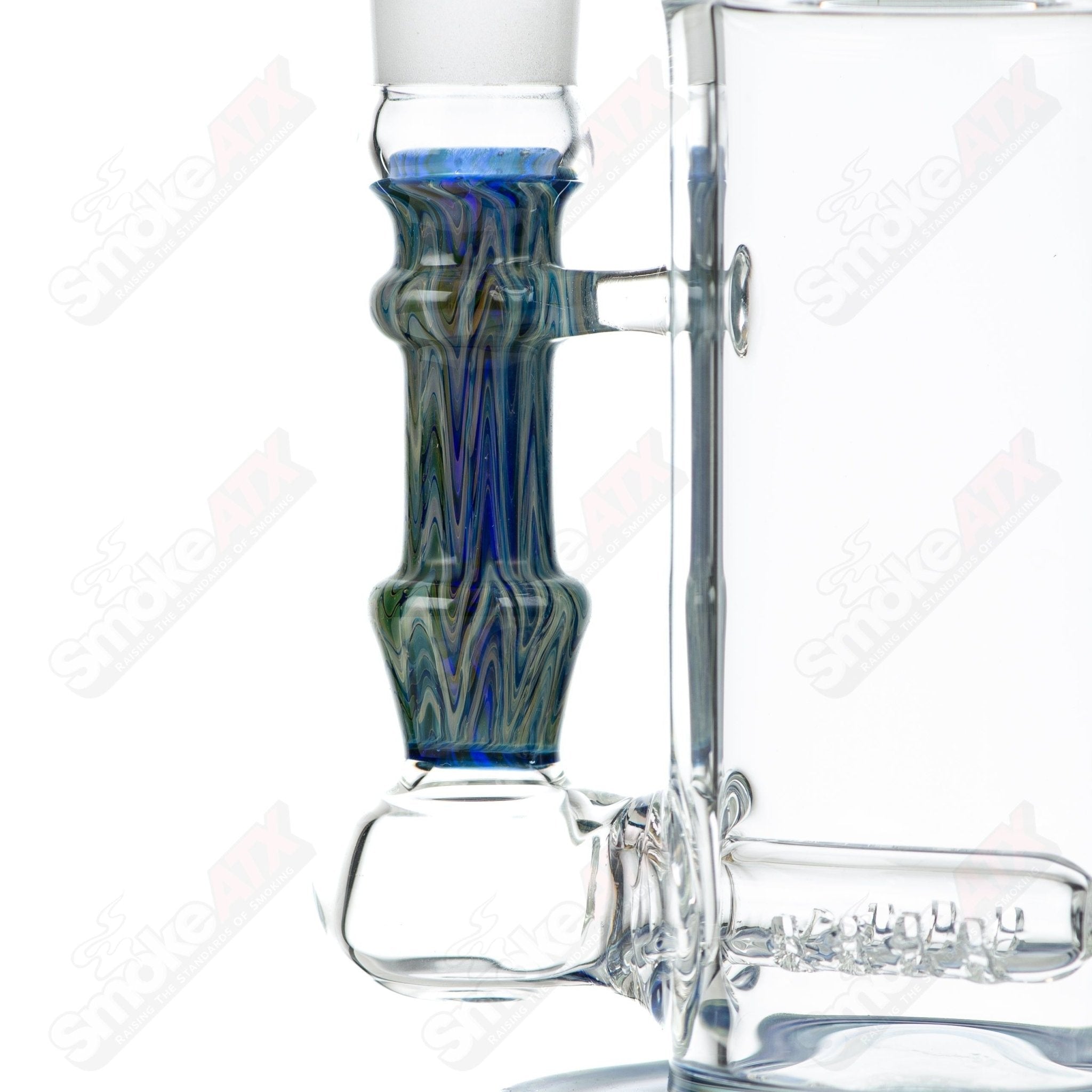 Tagle Glass inline tube bubbler with 18mm and 50mm wrap and rake design, crafted from clear glass for smooth smoking experience.