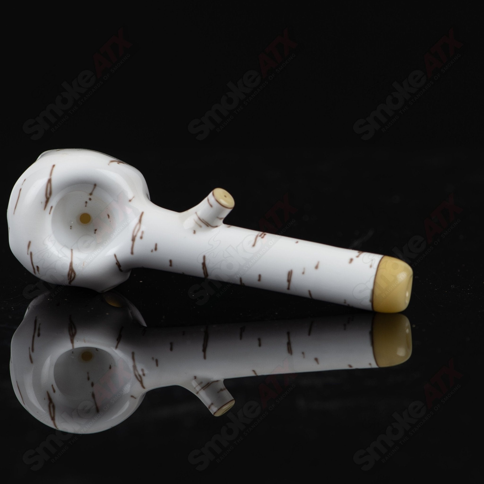 Foster Glass Heady Glass Birch Skull Spoon Hand Pipe in clear glass with detailed birch bark design and skull shape.
