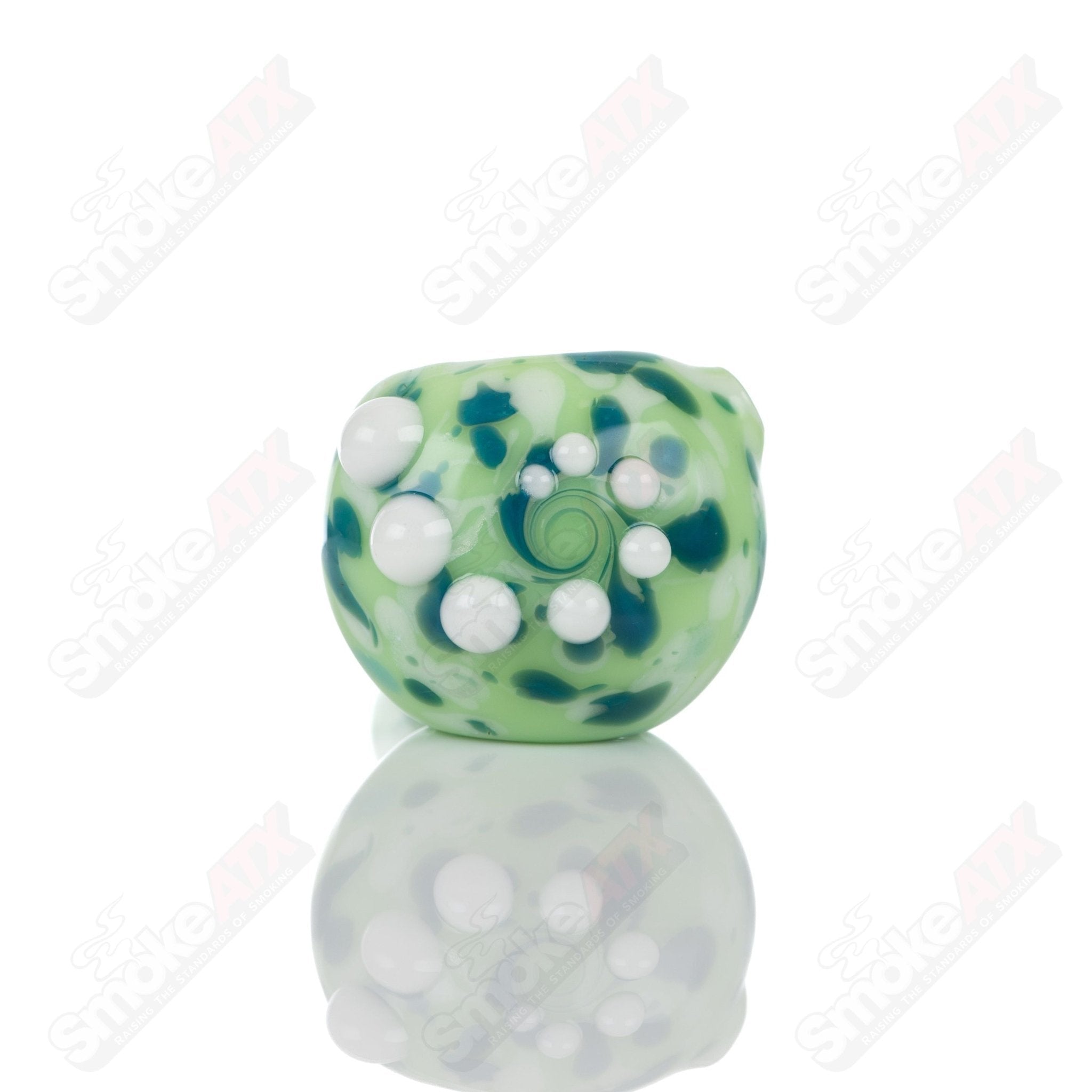 Colorful kiwi splatter glass spoon pipe by Adventures In Glass Blowing, showcasing intricate glass-blown design and smooth shape.