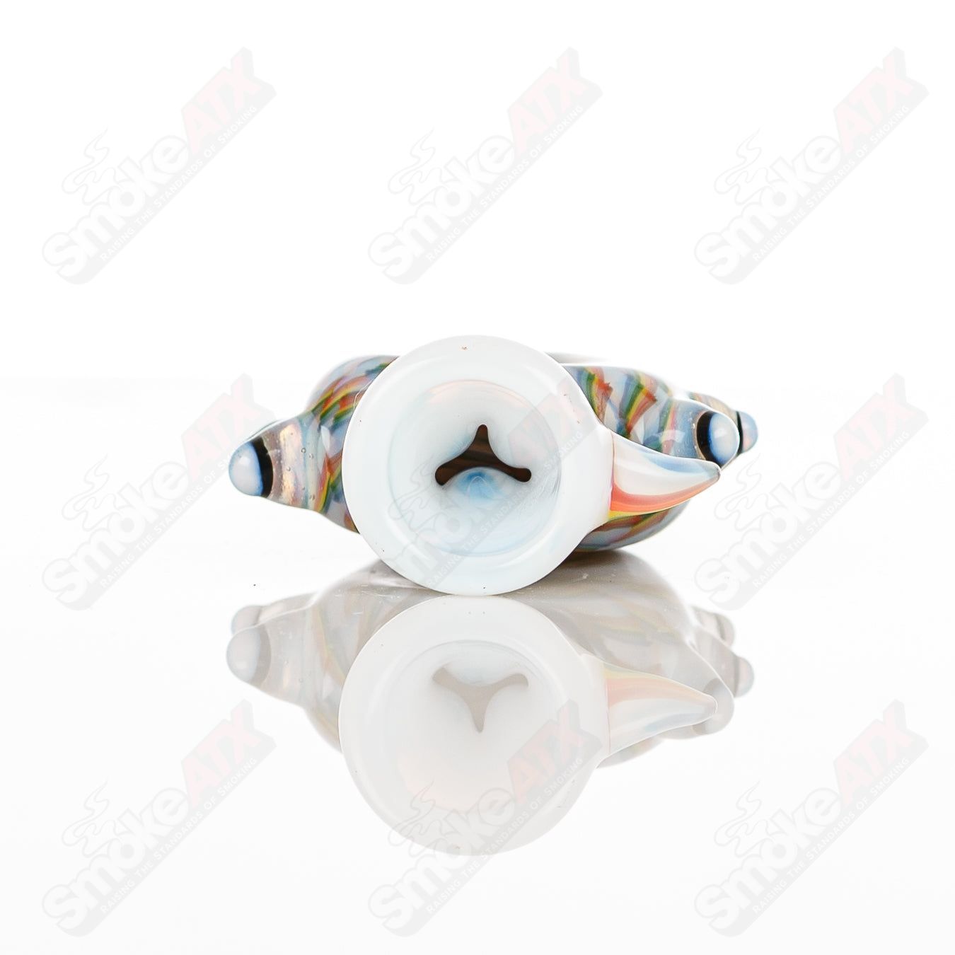Large glass Donut Chillum by Baby Dabs, featuring a colorful donut design, used for smoking concentrates.