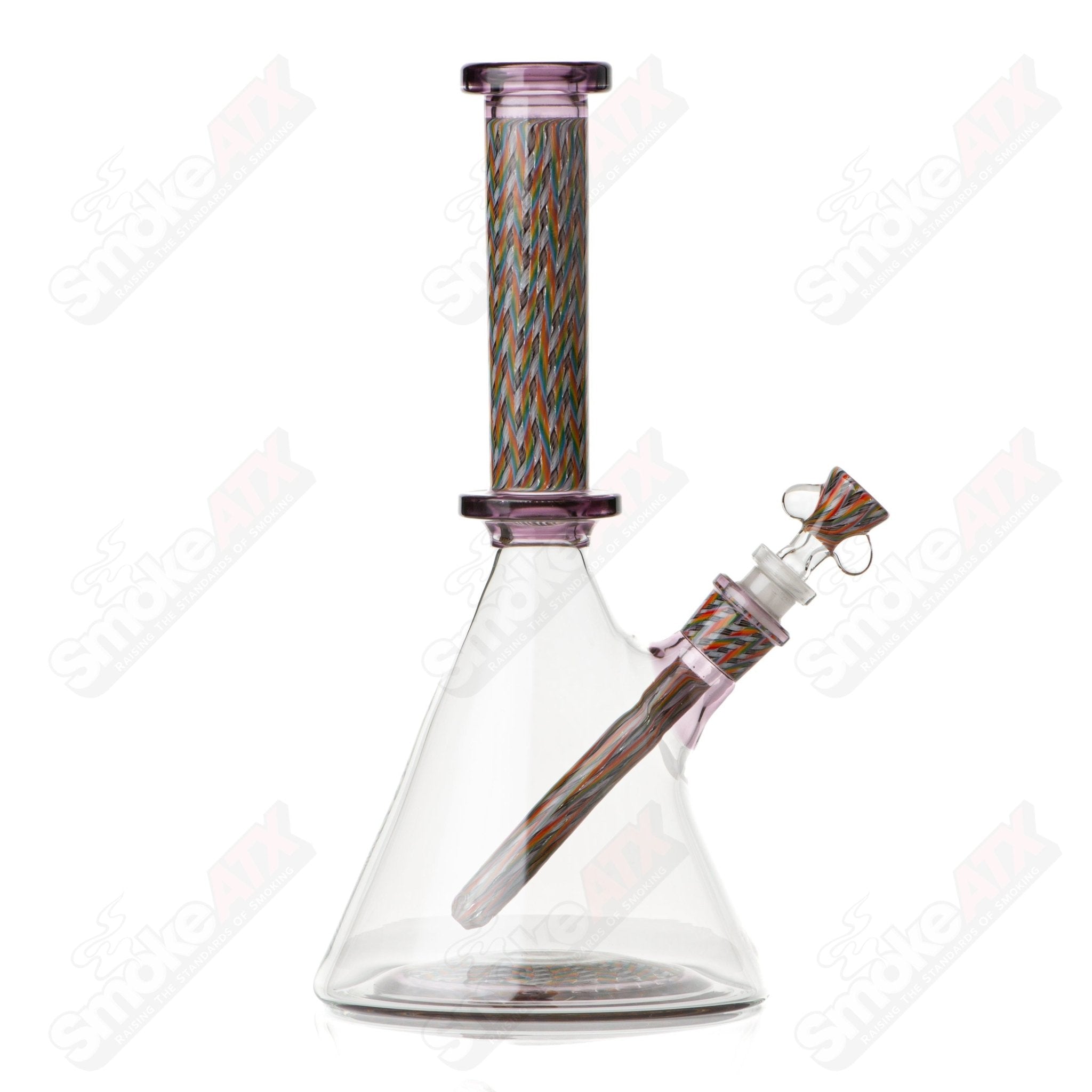 Glass beaker from Stephan Peirce Glass x Harold Cooney Heady Glass collection, showcasing clear, cylindrical design with artistic details.