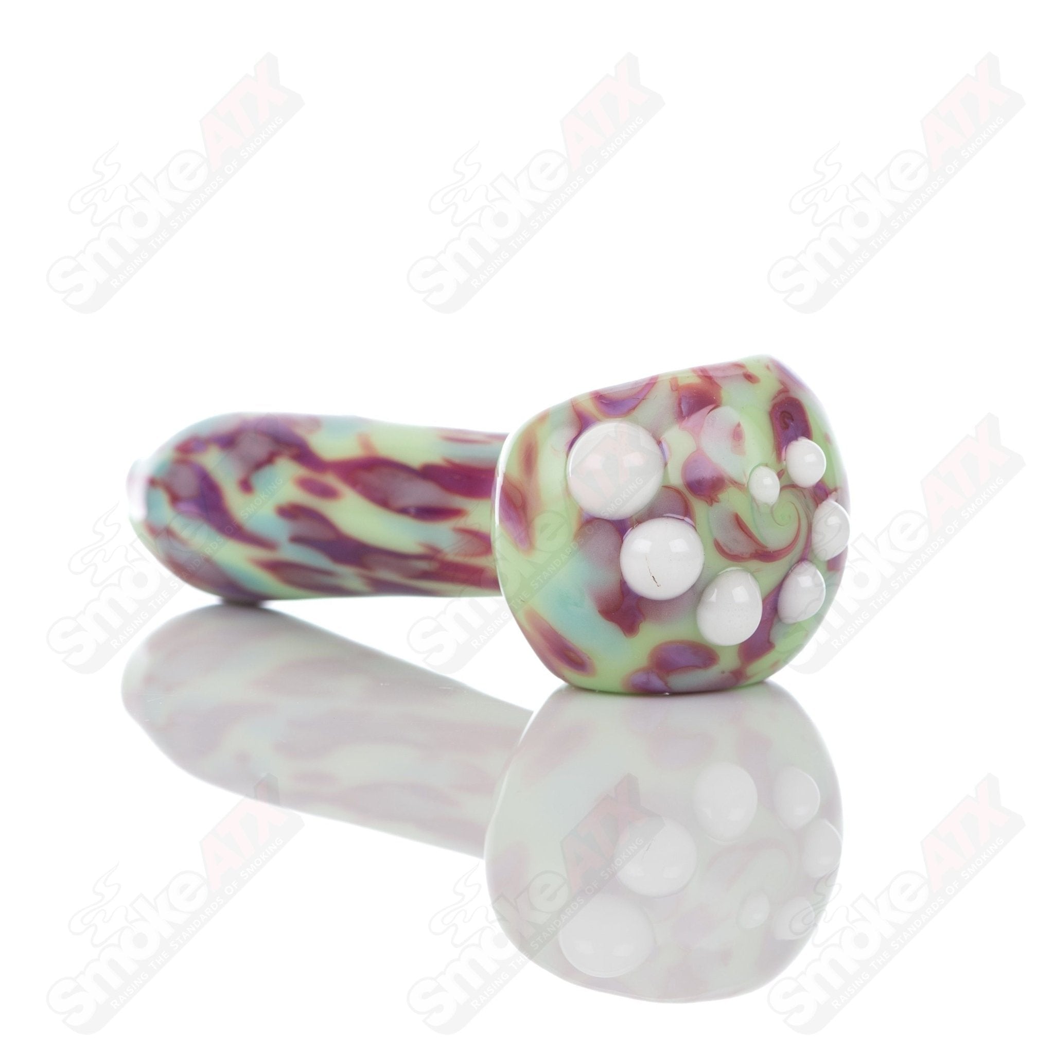 Colorful Kiwi splatter glass spoon pipe by Adventures In Glass Blowing, showcasing intricate glass art and vibrant design details.