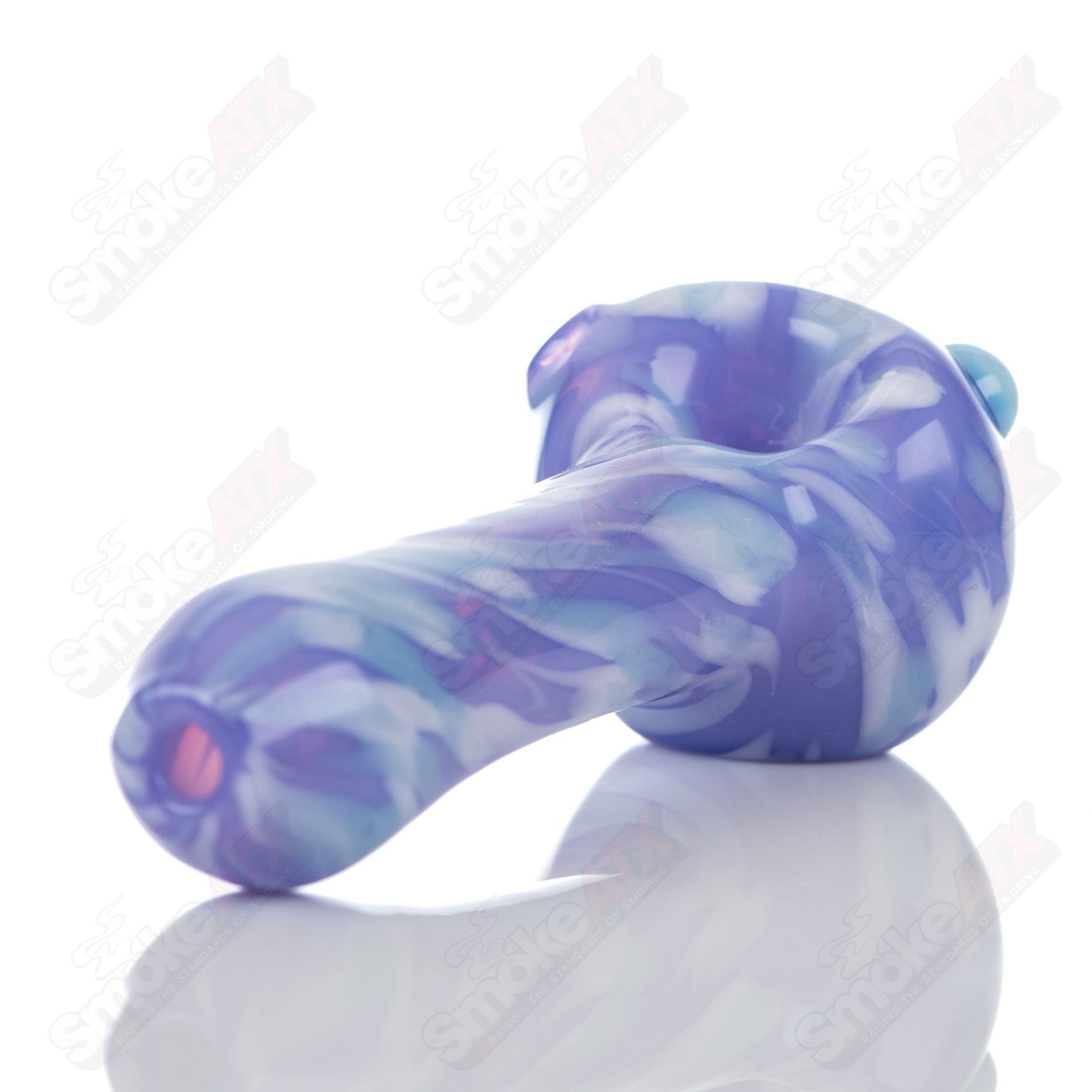 Purple splatter glass spoon pipe from Adventures In Glass Blowing, featuring a colorful, artistic design for smoking accessories.