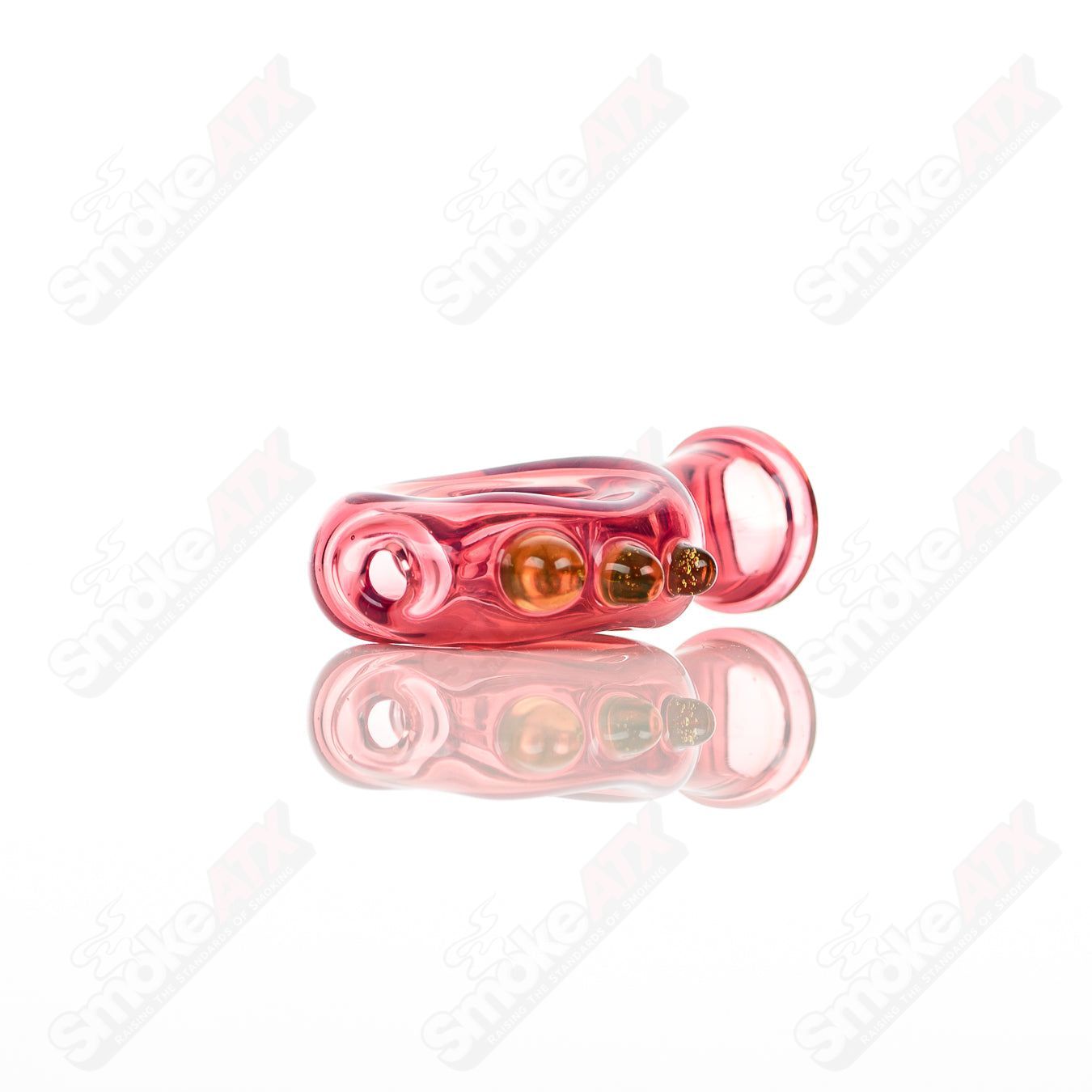 Large glass donut chillum by Baby Dabs, designed for dabbing, featuring a colorful donut shape and clear glass construction.
