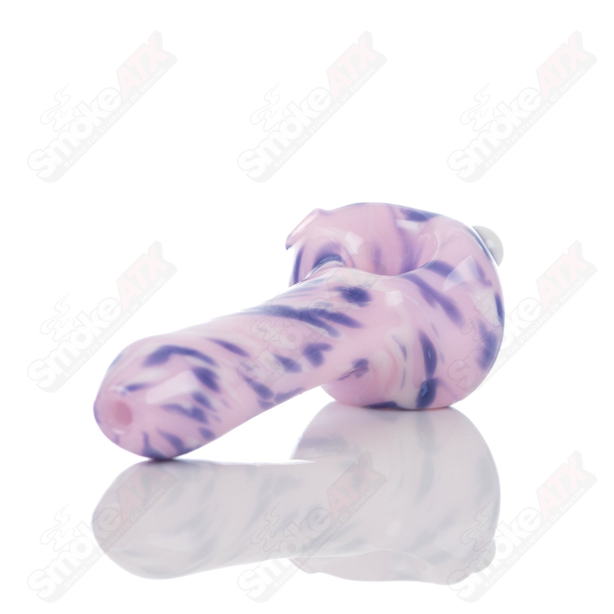 Pink splatter glass spoon pipe by Adventures In Glass Blowing, showcasing a colorful, handcrafted smoking pipe with intricate design details.