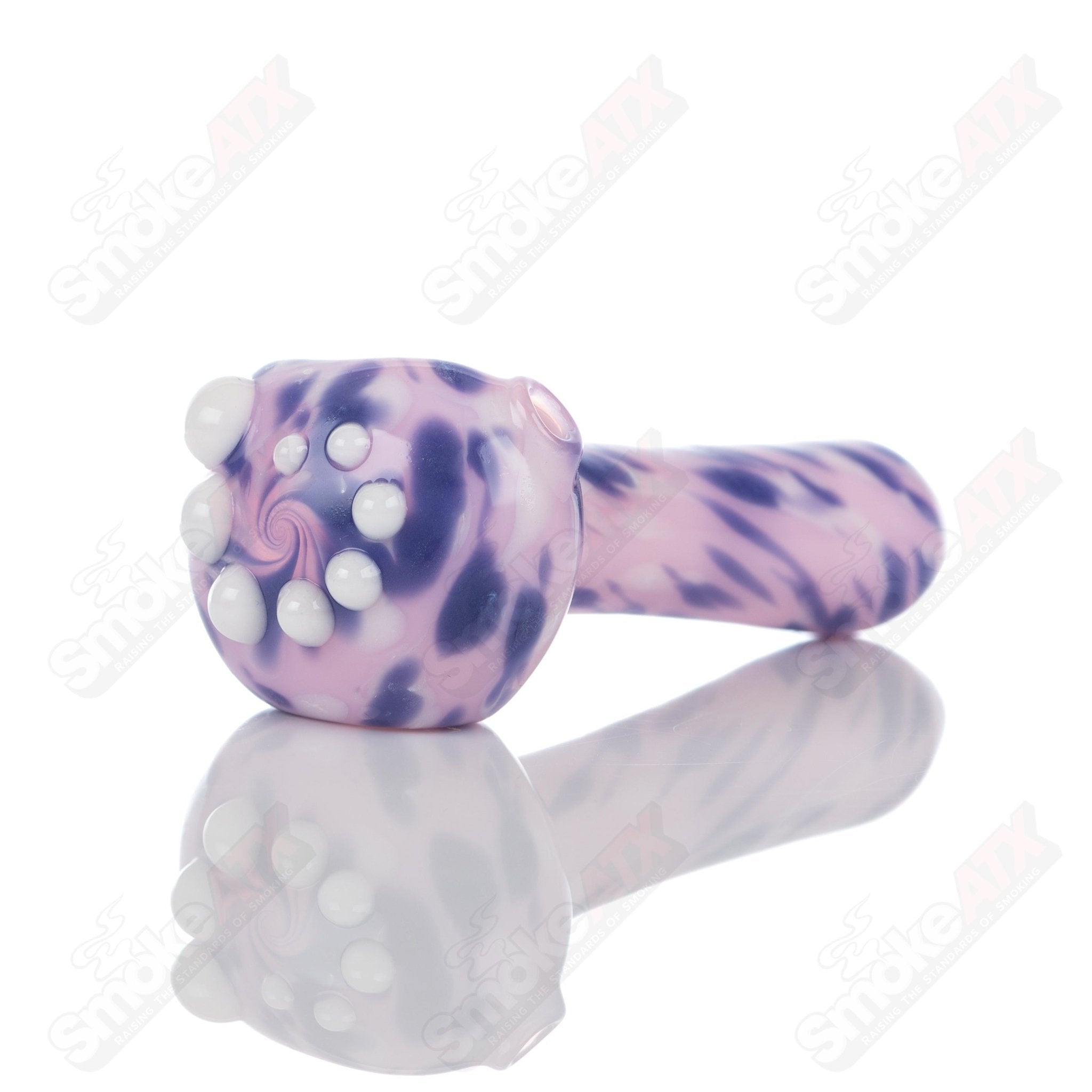 Pink splatter glass spoon pipe from Adventures In Glass Blowing, featuring a colorful, artistic design ideal for smoking use.