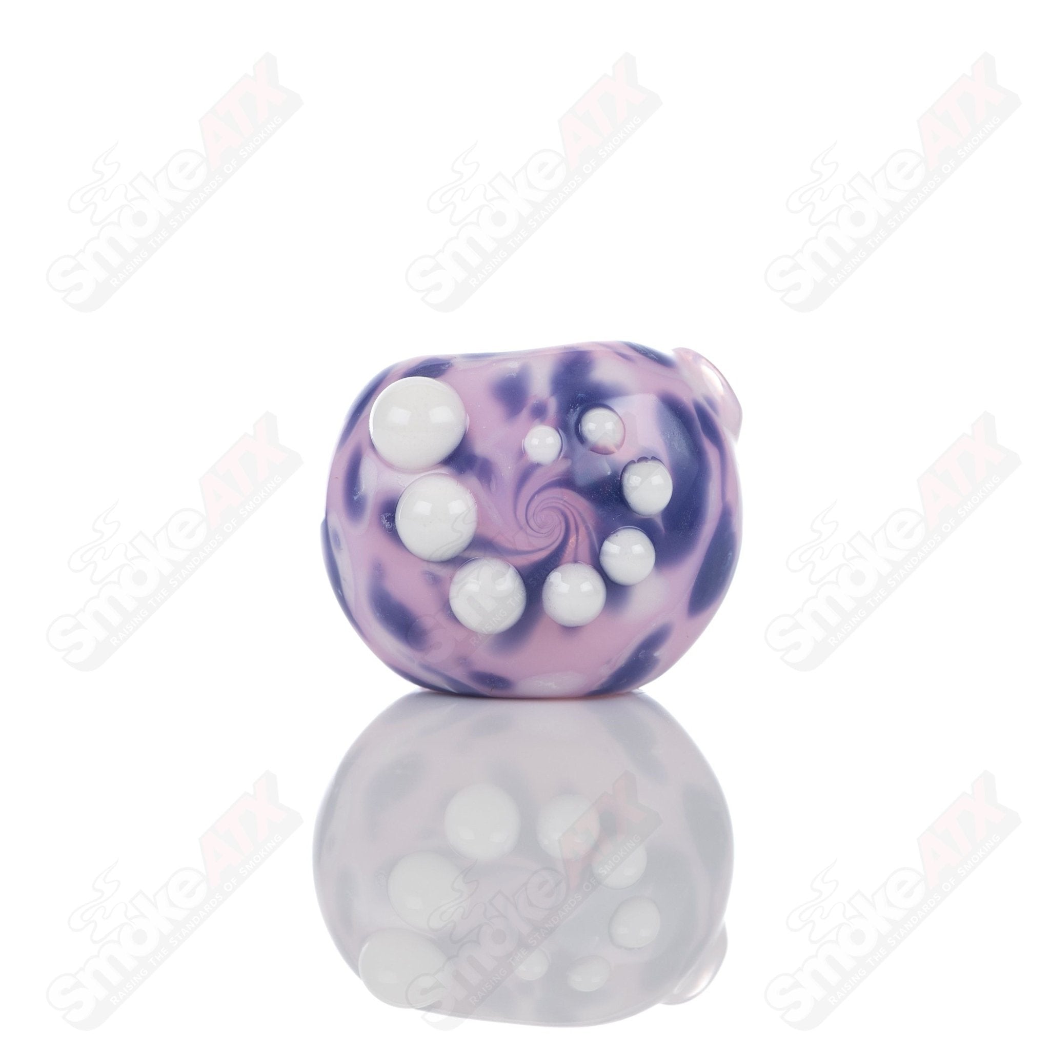 Pink splatter glass spoon pipe from Adventures In Glass Blowing, featuring a colorful, artistic design for smoking accessory.