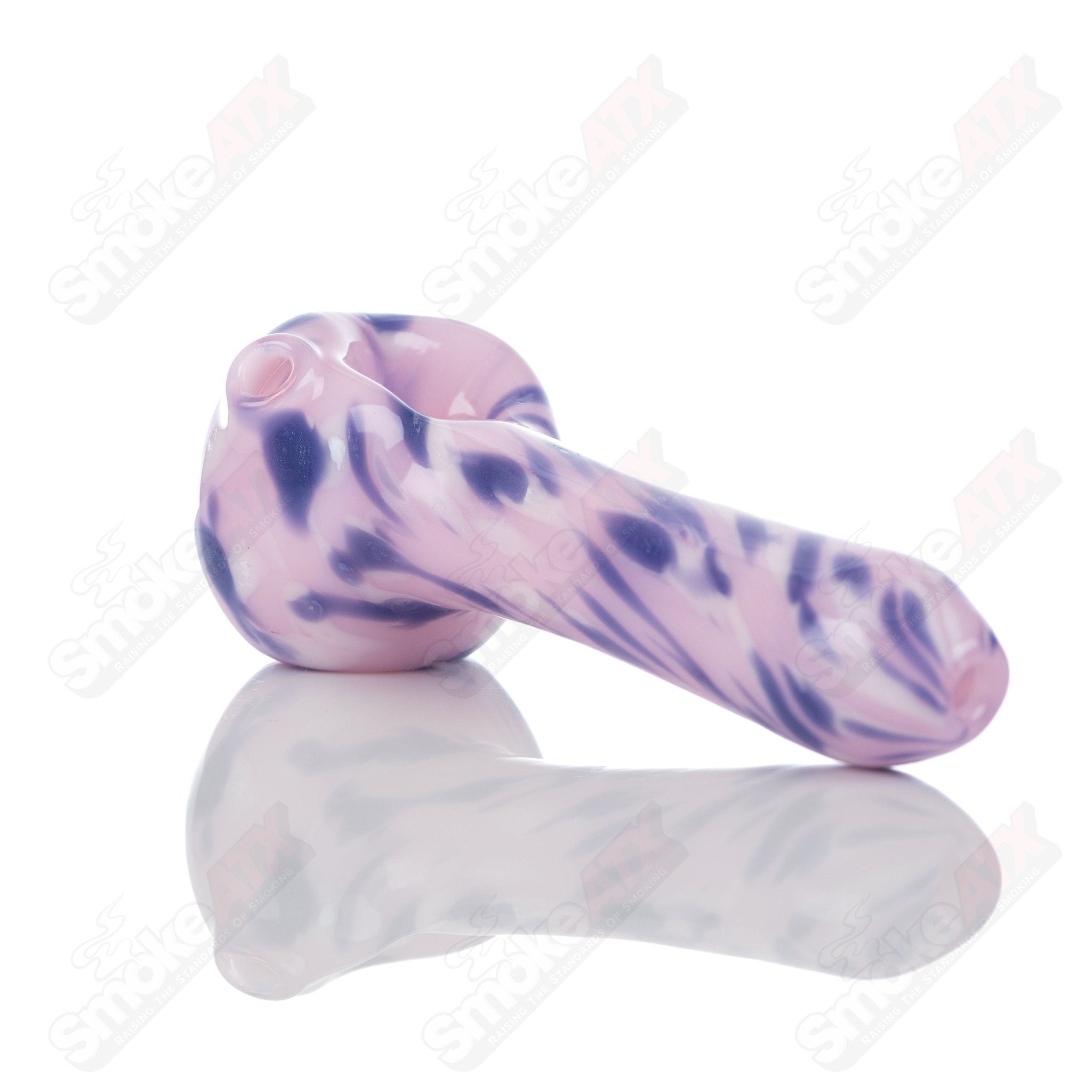 Pink splatter glass spoon pipe from Adventures In Glass Blowing, featuring a vibrant design and smooth mouthpiece for smoking.