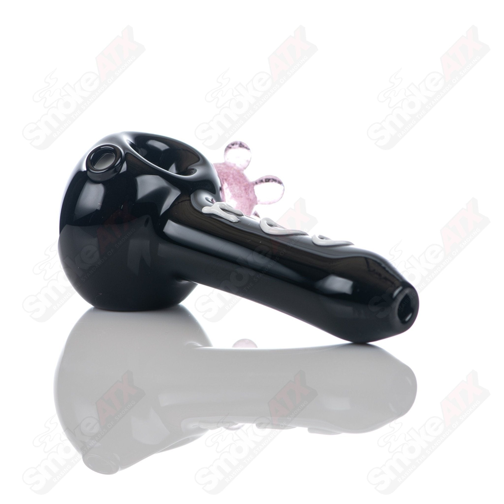 Black cow print glass spoon pipe from Adventures In Glass Blowing, featuring detailed cow print design for smoking.