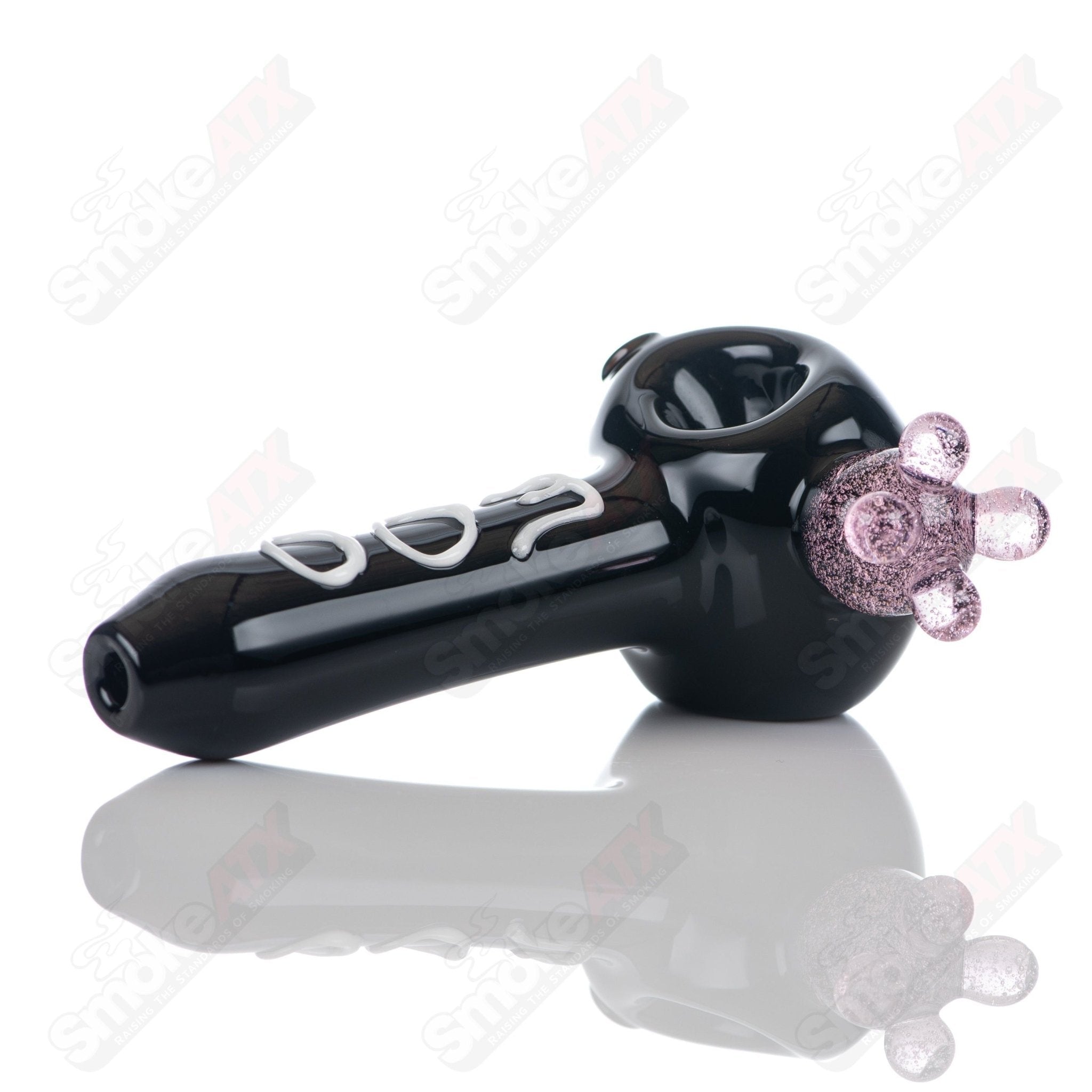 Black cow print glass spoon pipe by Adventures In Glass Blowing, featuring a detailed cow pattern and smooth glass finish.